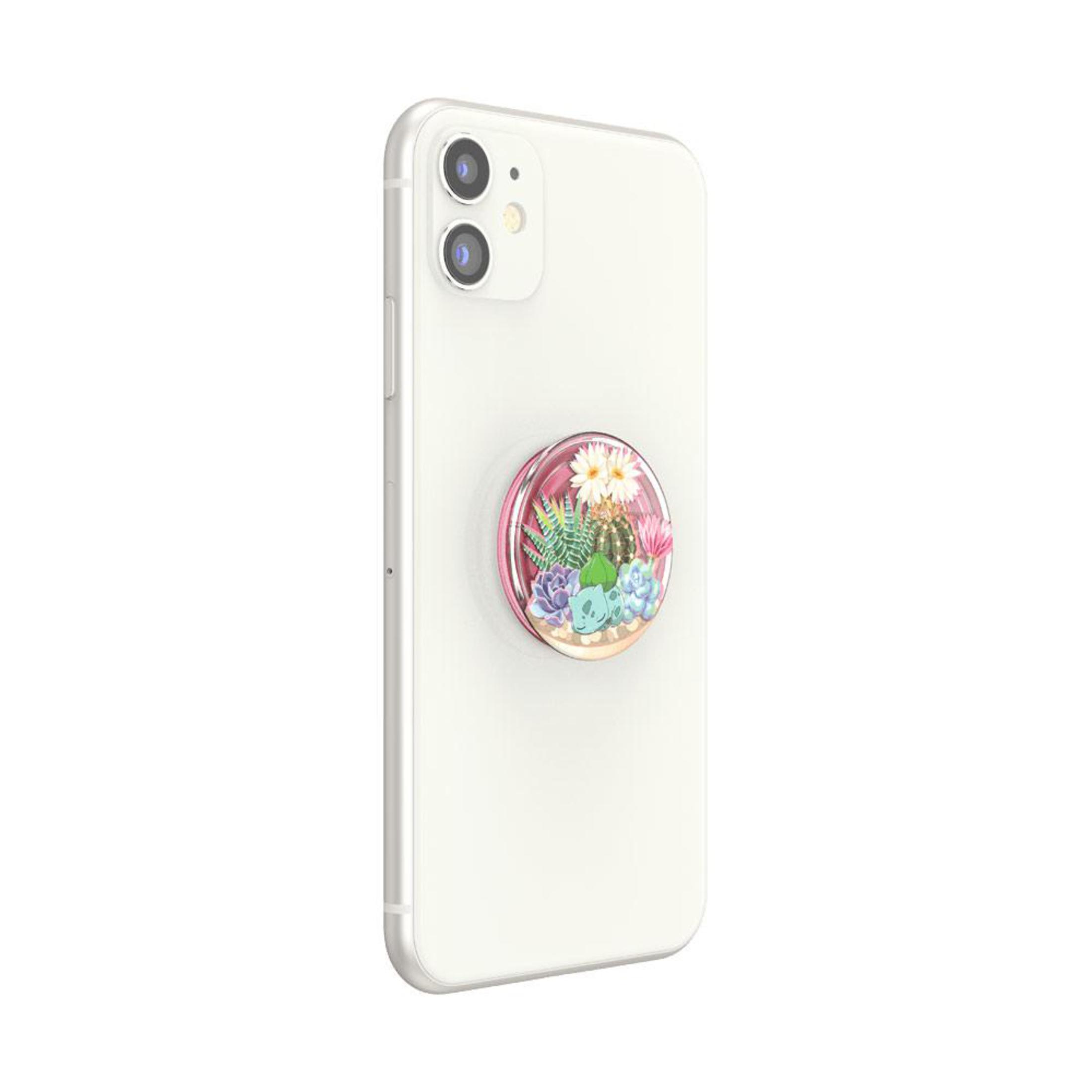 Un telefono bianco con un'impugnatura pop-up rosa con un design di cactus e fiori.