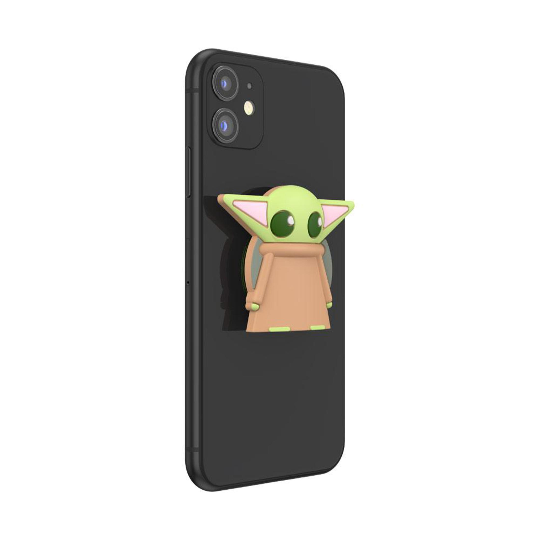 Ein schwarzes Telefon mit einem Baby Yoda PopSocket. Yoda ist grün, beige und rosa.