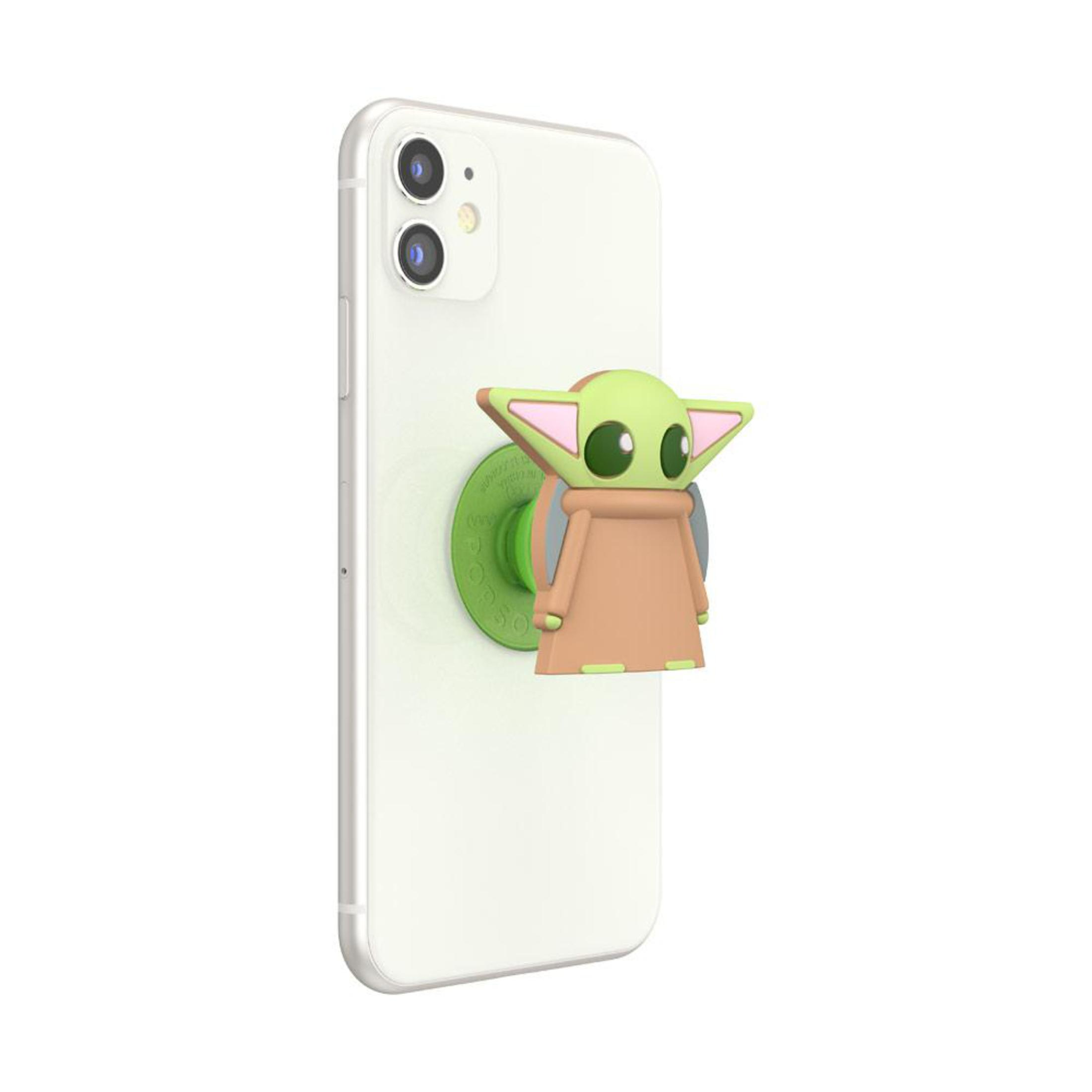 Ein weißes Telefon mit einem grünen PopSocket. Baby Yoda ist grün, beige und rosa.