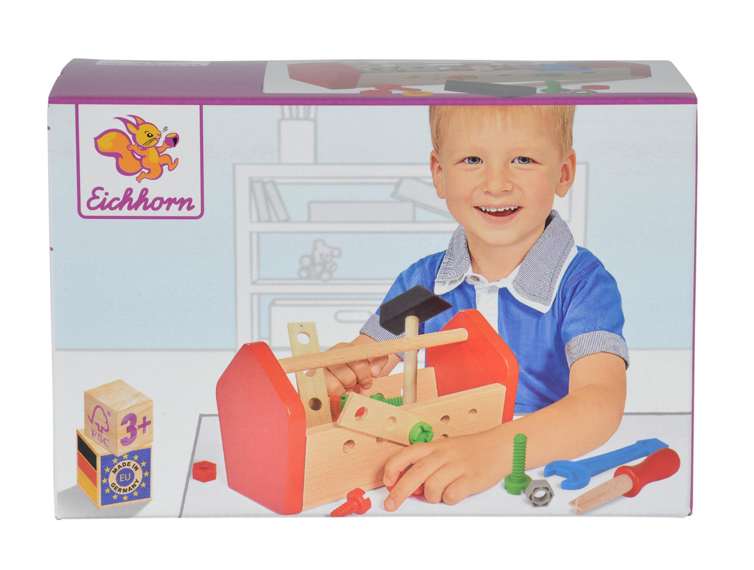 A toy toolbox with a boy on the box cover. Tools are on the table.