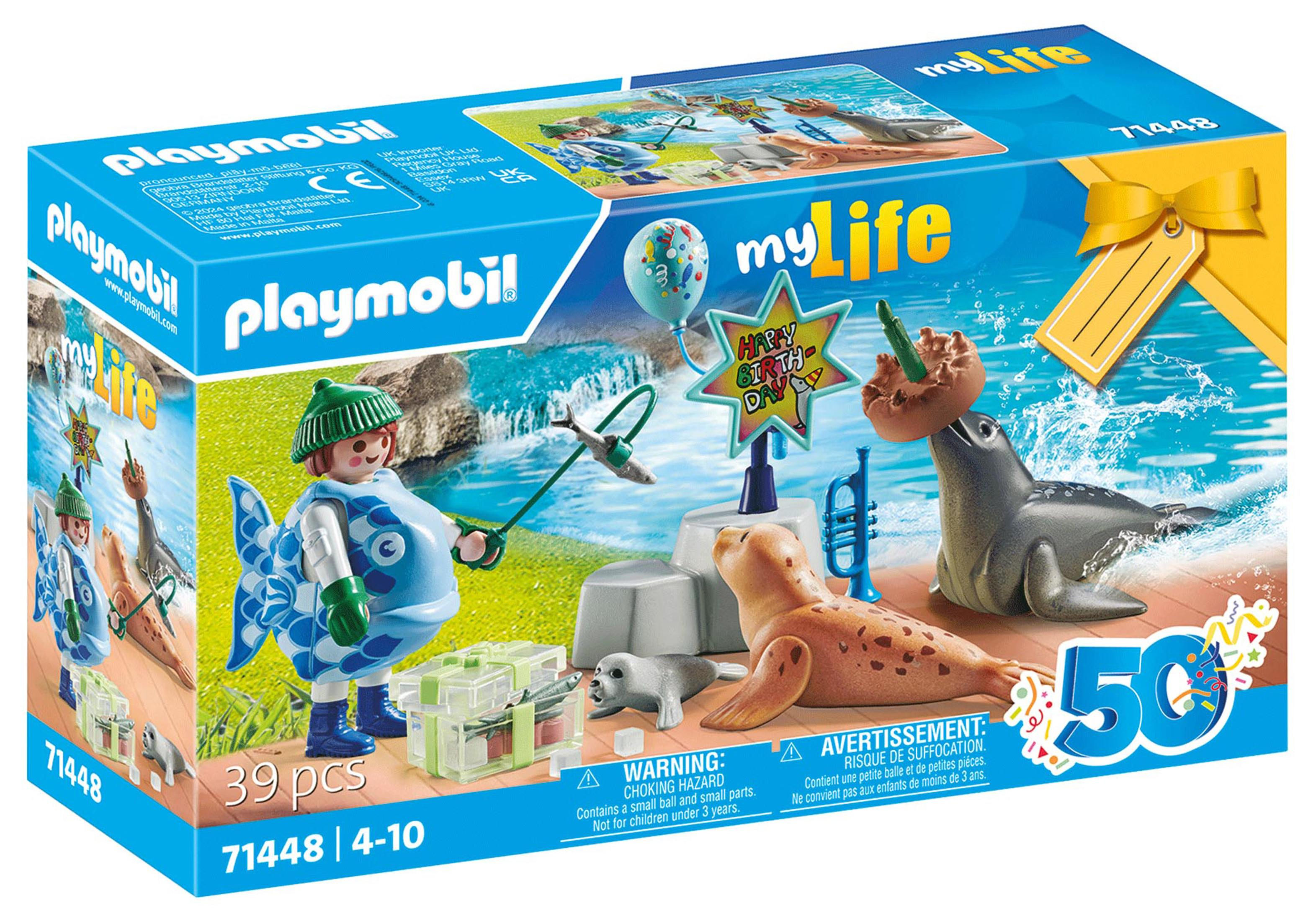 Ein Playmobil-Box-Set. Es zeigt ein als Fisch verkleidetes Kind mit Robben und einer Geburtstags-Szene.