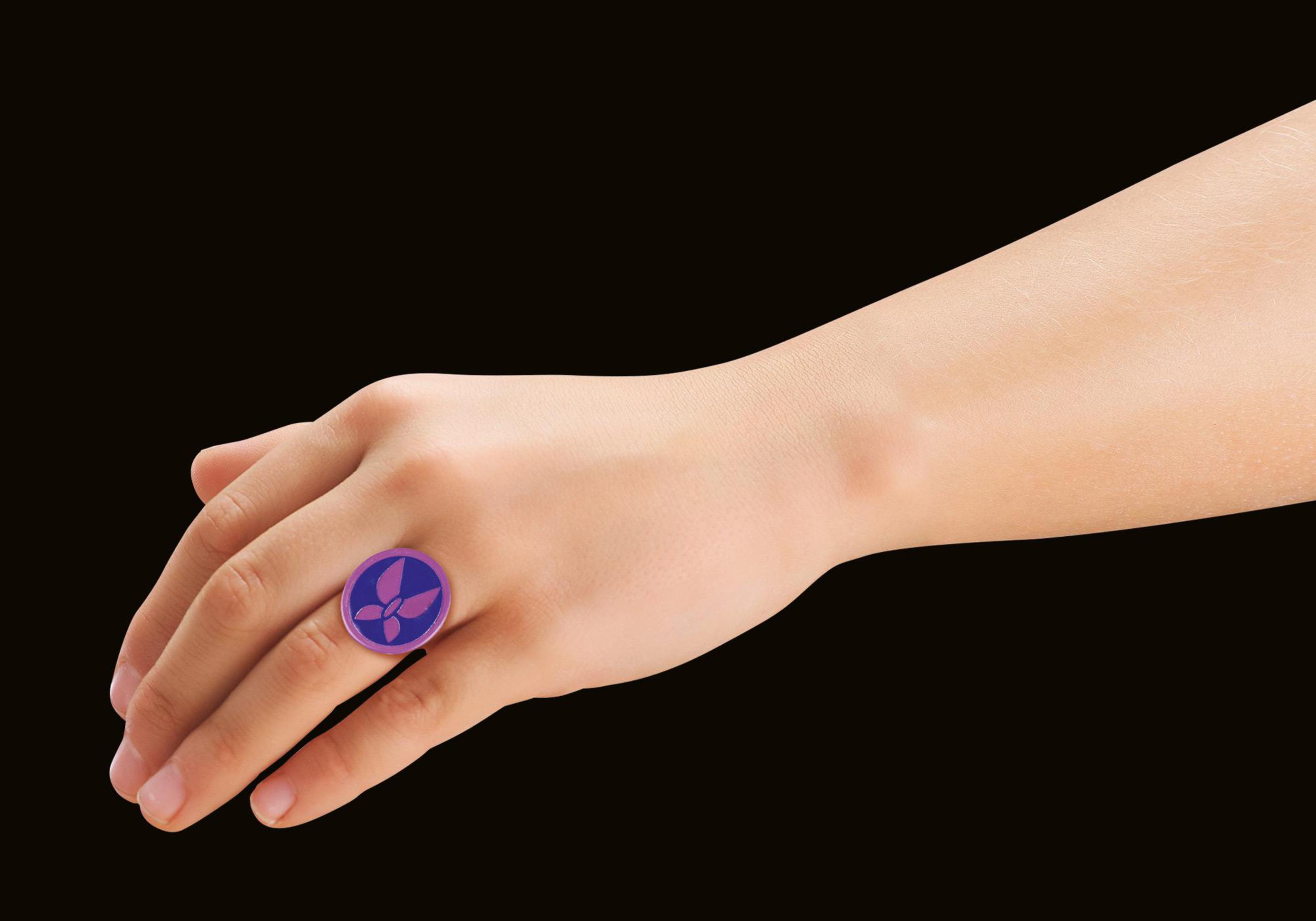 Hand, die einen Ring mit lila und blauem Design hält.