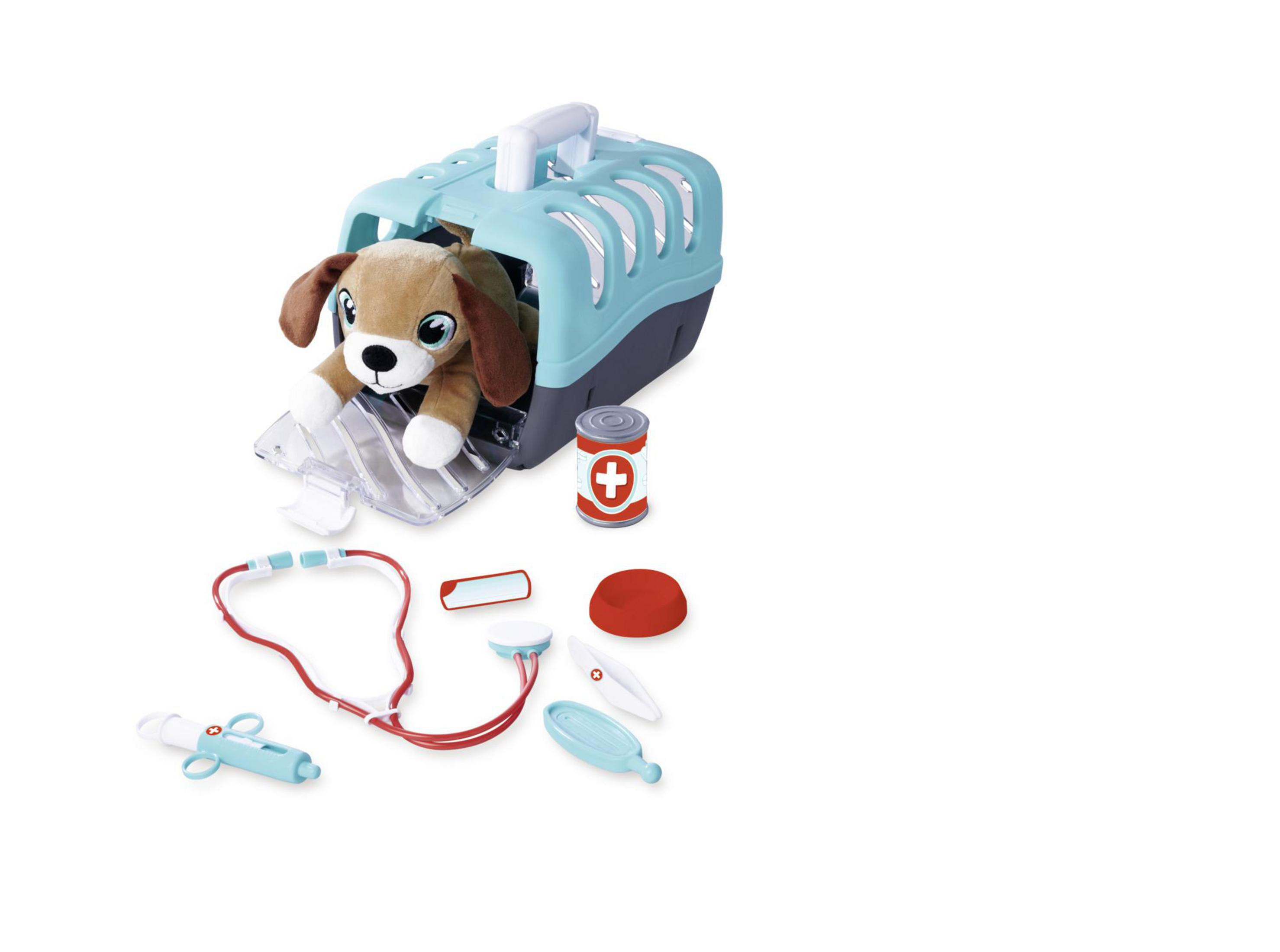 Ein Spielzeug-Tierarztset mit einem Hund in einer Transportbox, einem Stethoskop und anderen Werkzeugen.