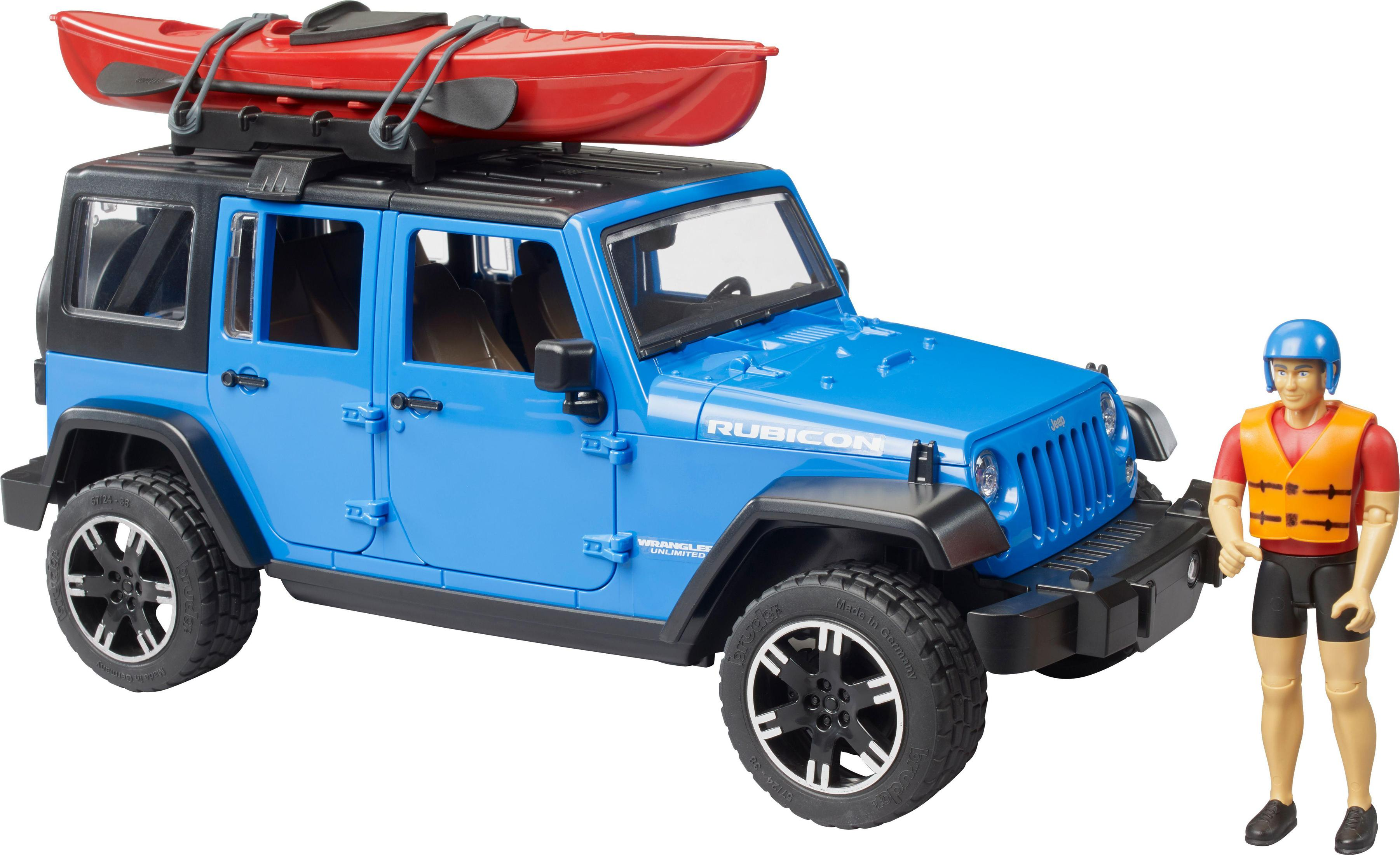 Ein blaues Spielzeug-Jeep mit einem roten Kajak auf dem Dach und einem Spielzeugmann. Hintergrund ist Feld und Himmel.