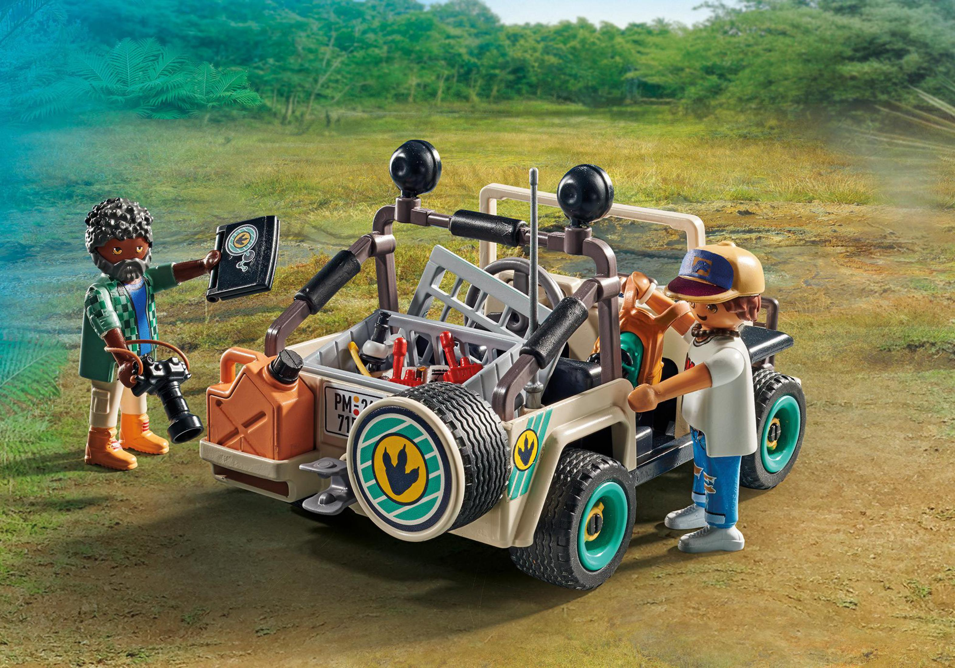 Set di giocattoli Playmobil con due figure e una jeep in un ambiente naturale.