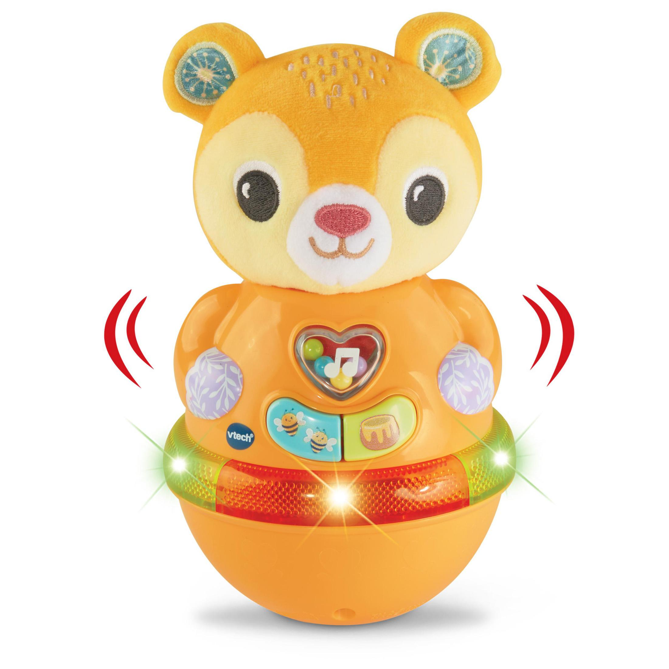 Ein orange-gelbes bärenförmiges Spielzeug mit musikalischem Herzen, Knöpfen und grünen Lichtern.