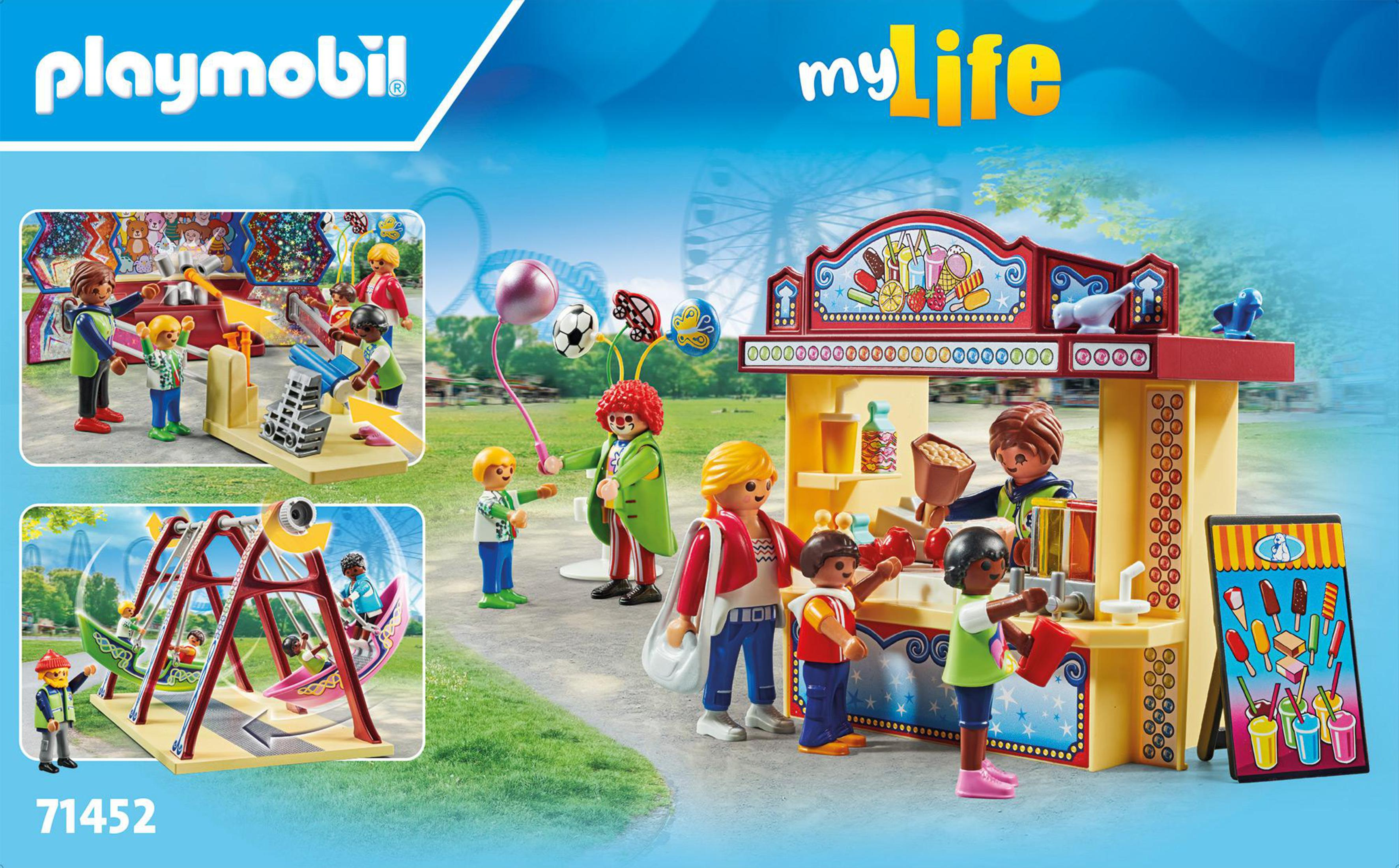 Escena Playmobil con figuras en un carnaval con atracciones y un puesto de comida.