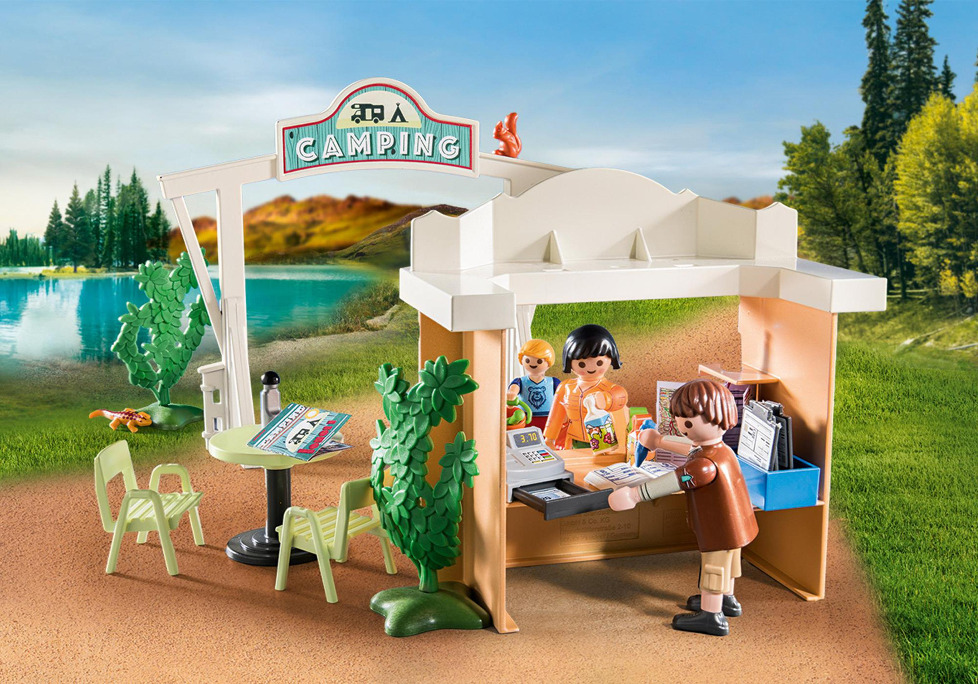 Un playset da campeggio Playmobil con personaggi, un chiosco da campeggio e attrezzature da campeggio, ambientato in un parco.