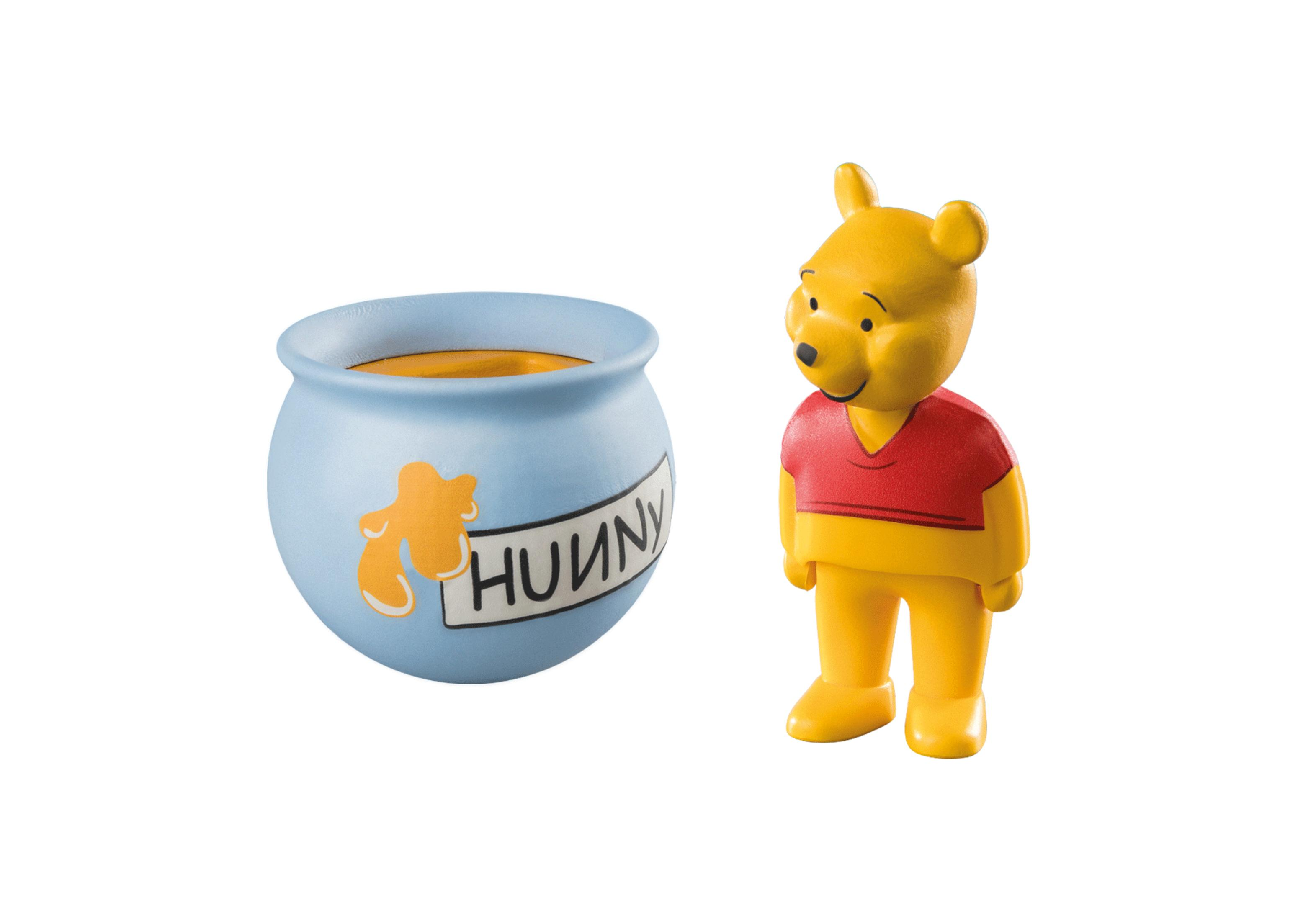 Winnie Puuh Figur und ein Honigtopf.
