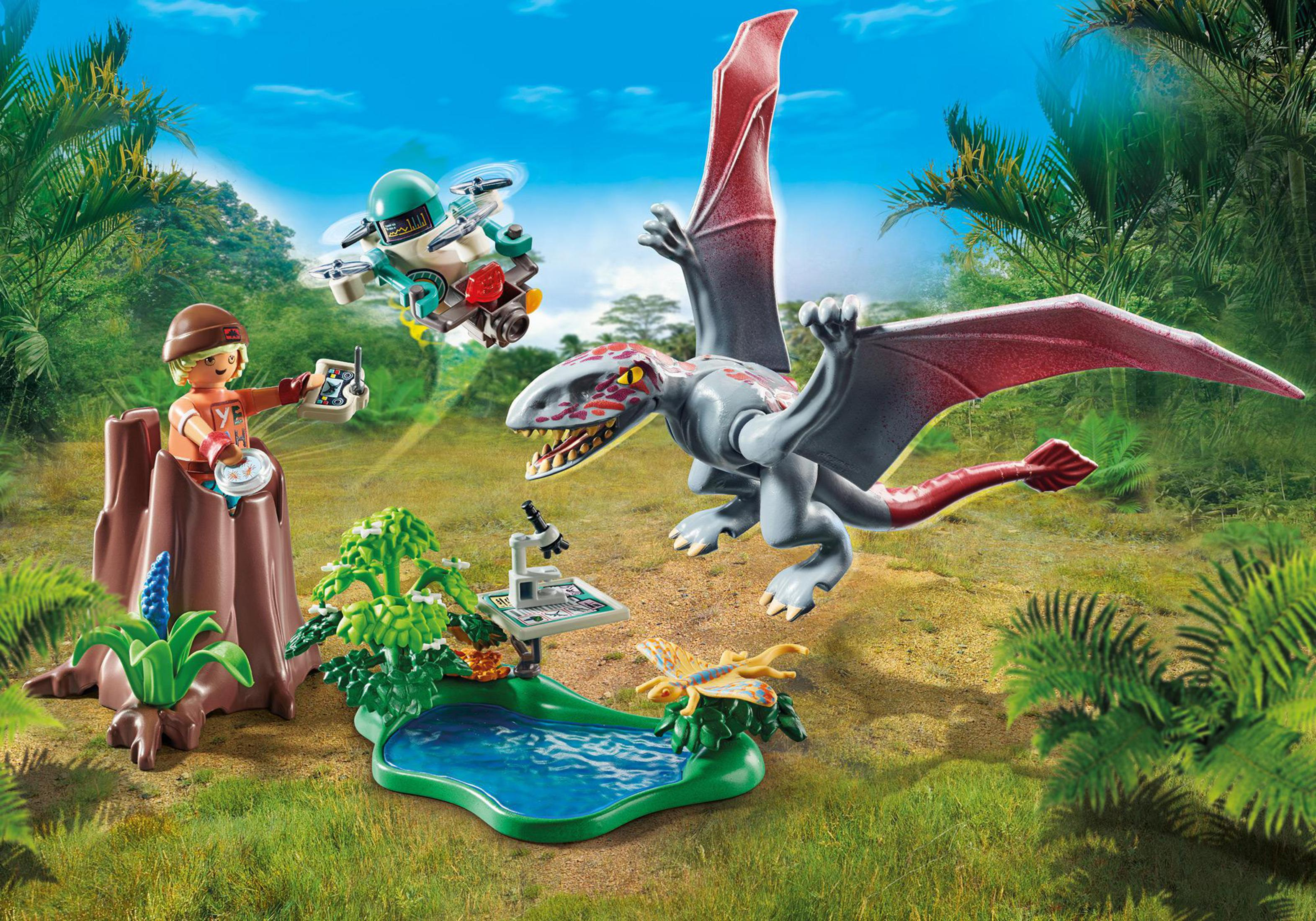 Una scena della giungla Playmobil con una persona, un pterodattilo, un drone e un piccolo stagno.