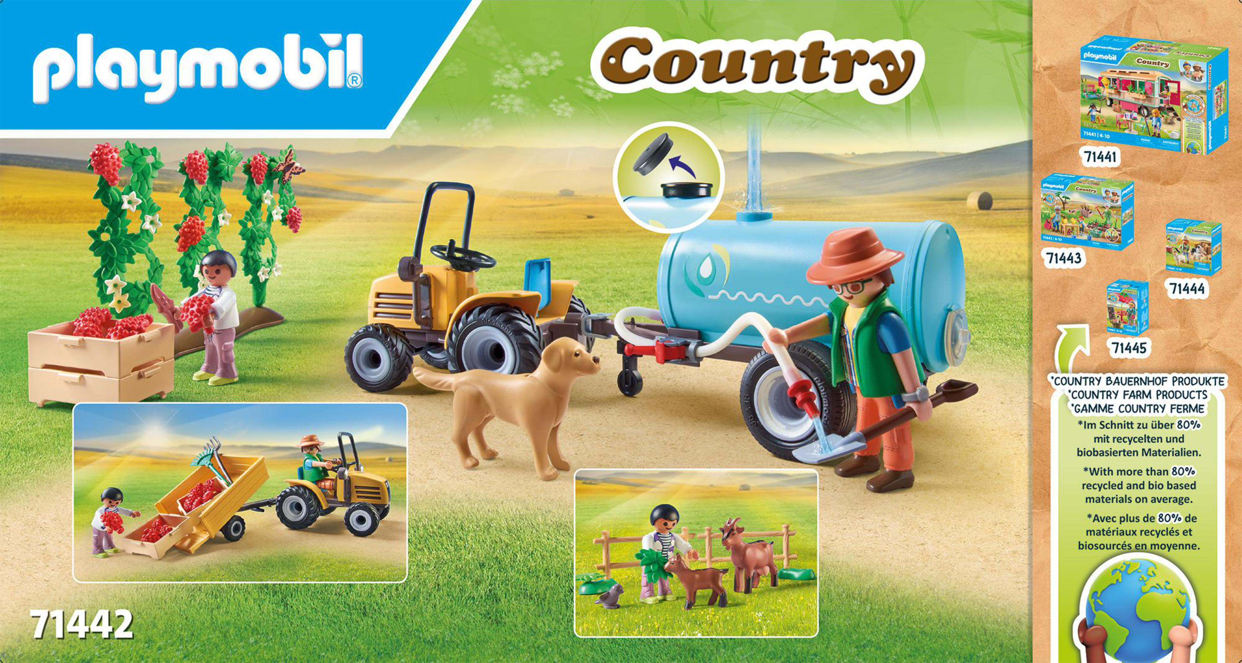 Scena della fattoria Playmobil Country con personaggi, trattore, rimorchio, cane ed elementi.