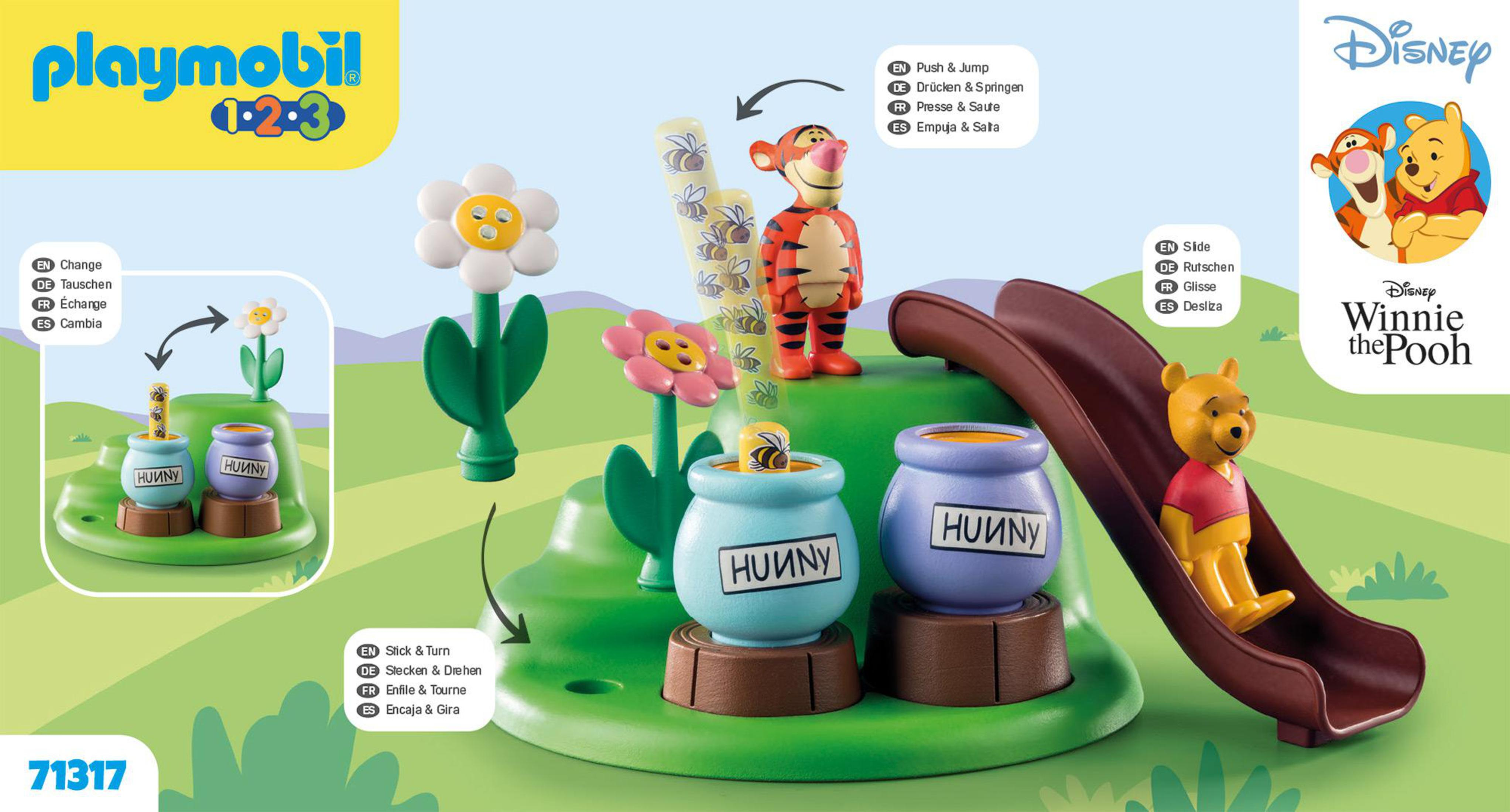 Ein Playmobil Winnie the Pooh Set mit Tigger auf einer Rutsche, Winnie am Boden und Blumen und Honigtöpfen.