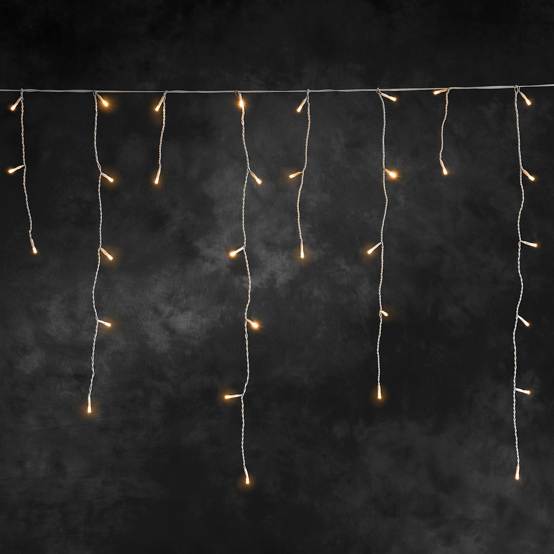 Lichterkette auf dunklem Hintergrund, mit vielen kleinen, leuchtenden Glühbirnen.