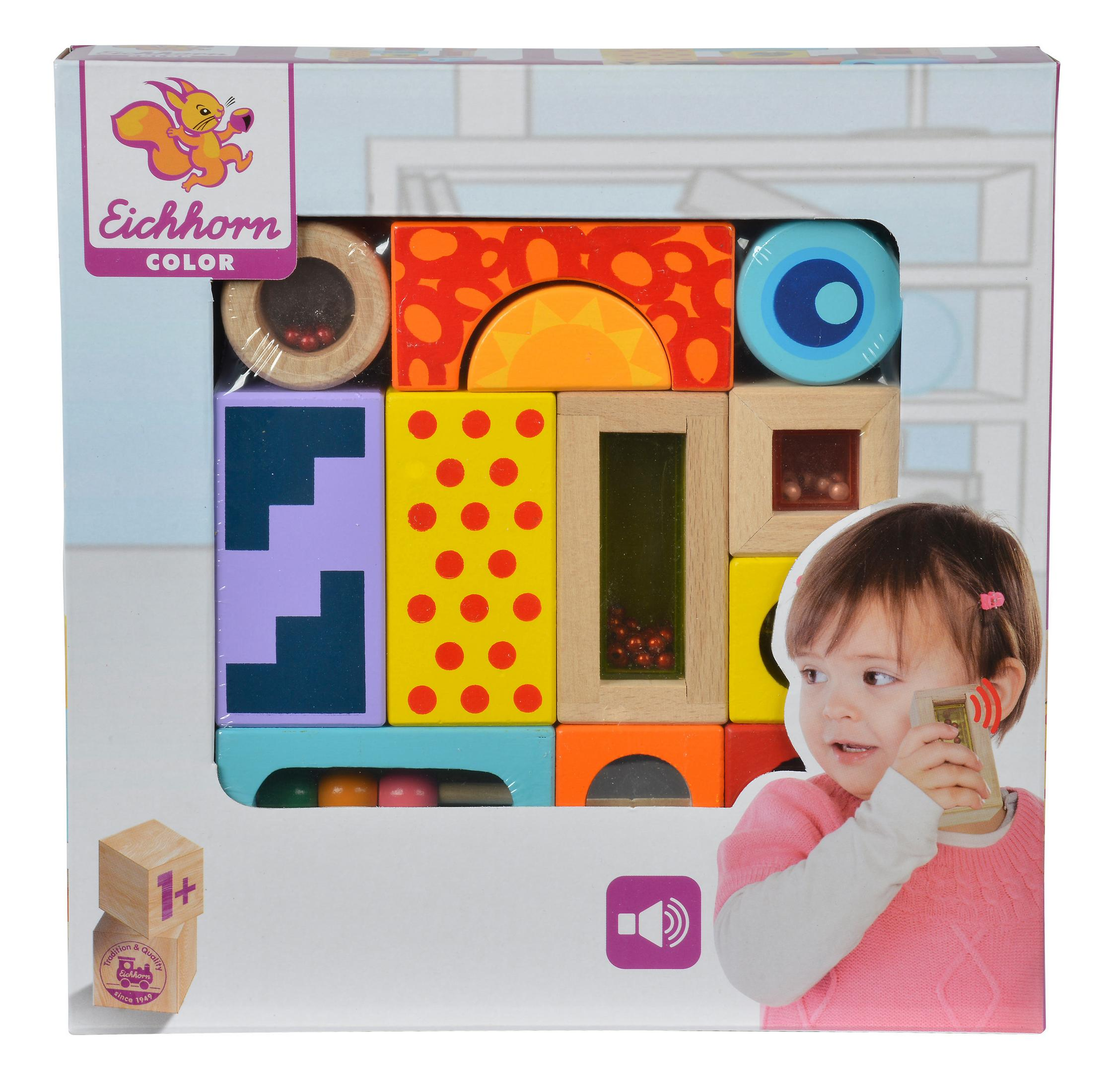 Ein Spielzeug-Blockset in einer Box mit einem Kindergesicht und einem Telefonspielzeug daneben.