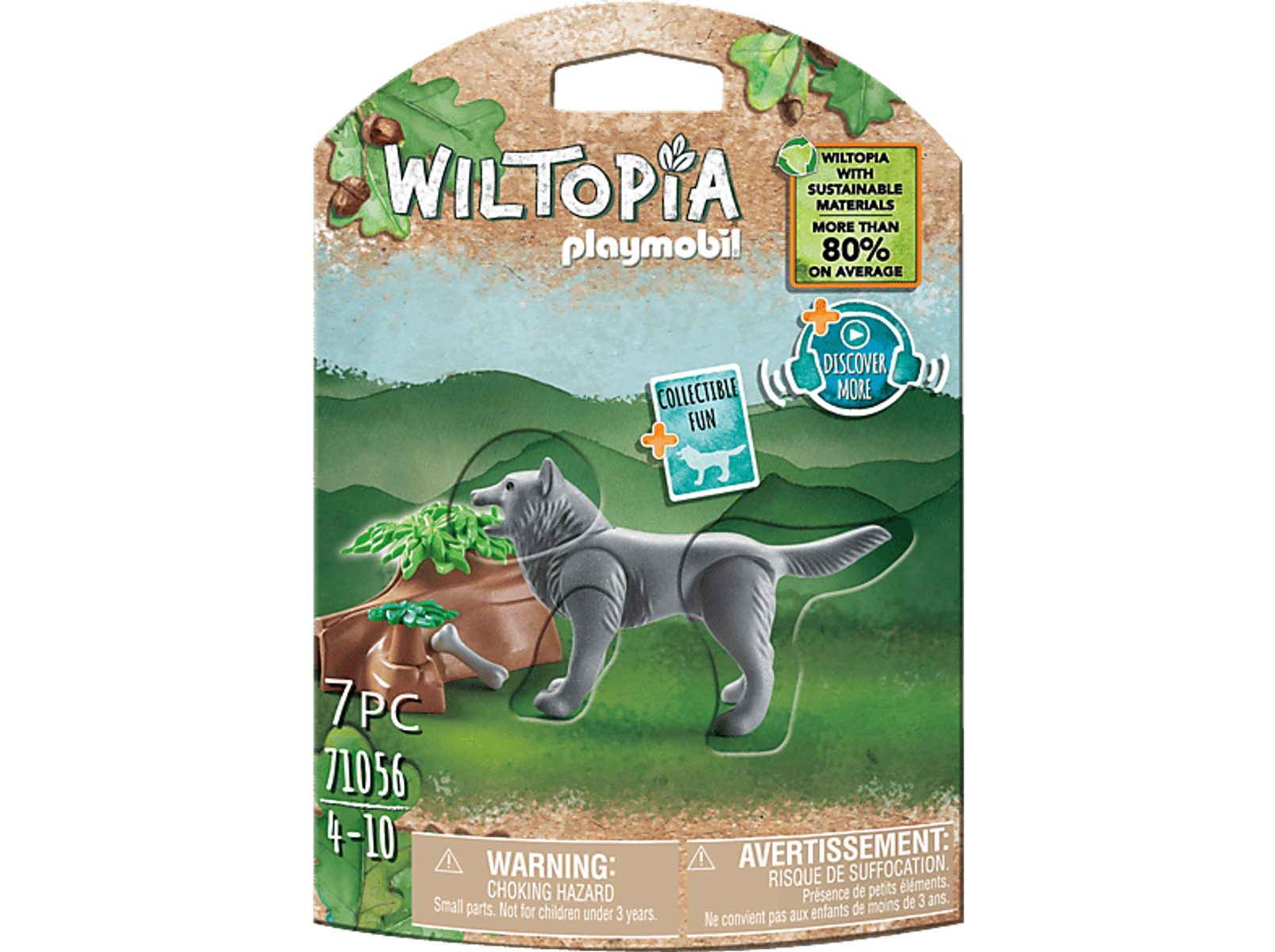 Zabawkowy wilk stoi przed drzewem i kością. Tło to zielono-brązowa sceneria.