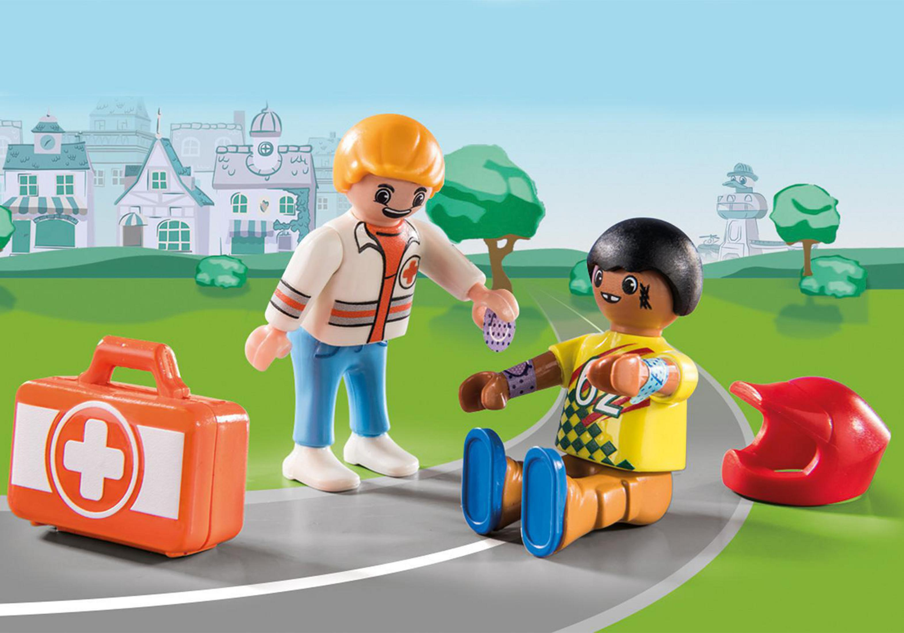 Scena Playmobil: figurki pomagające rannej osobie, z apteczką, kaskiem i drogą.