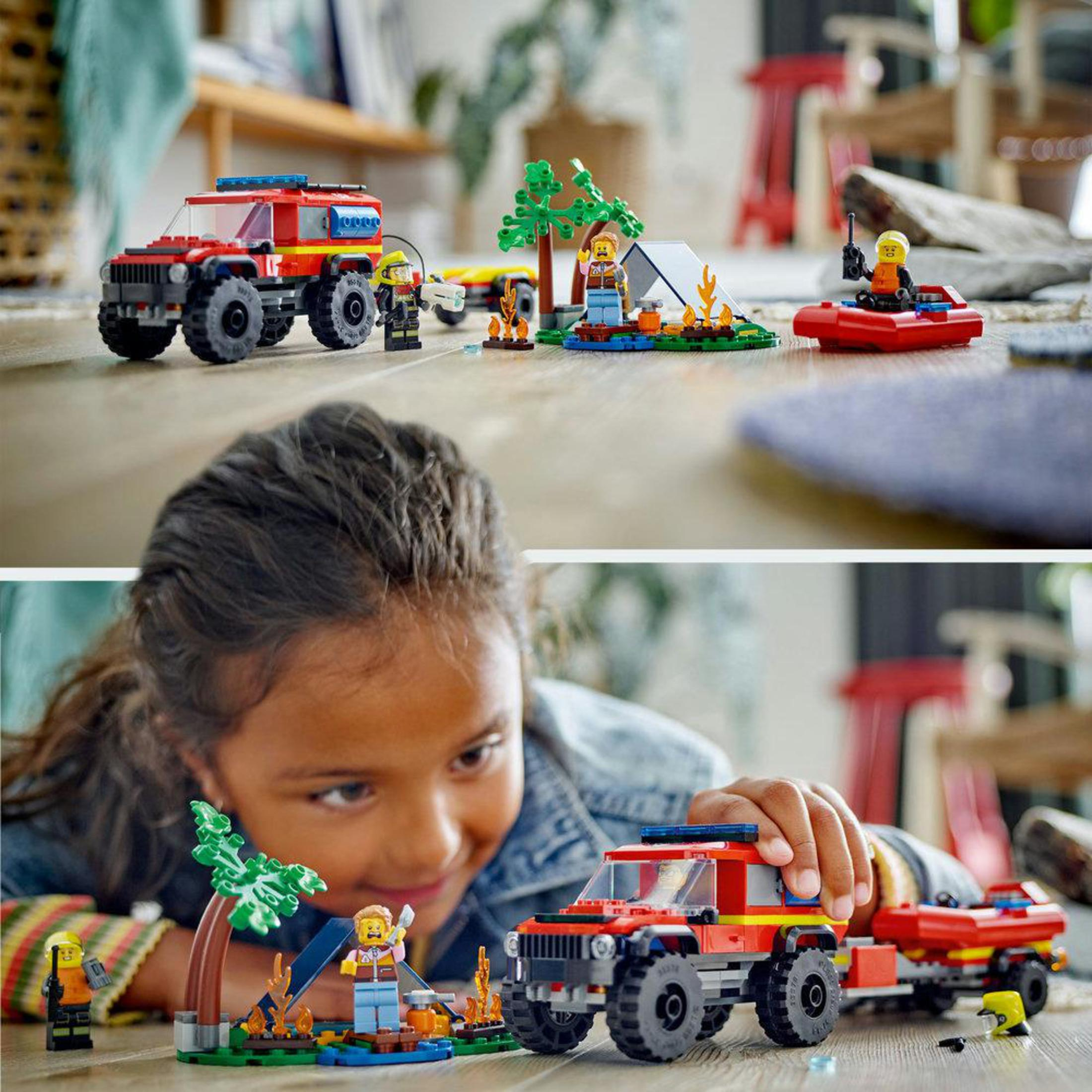 Ensemble Lego avec un camion de pompiers, une tente et des figurines. Une fille joue avec l'ensemble.