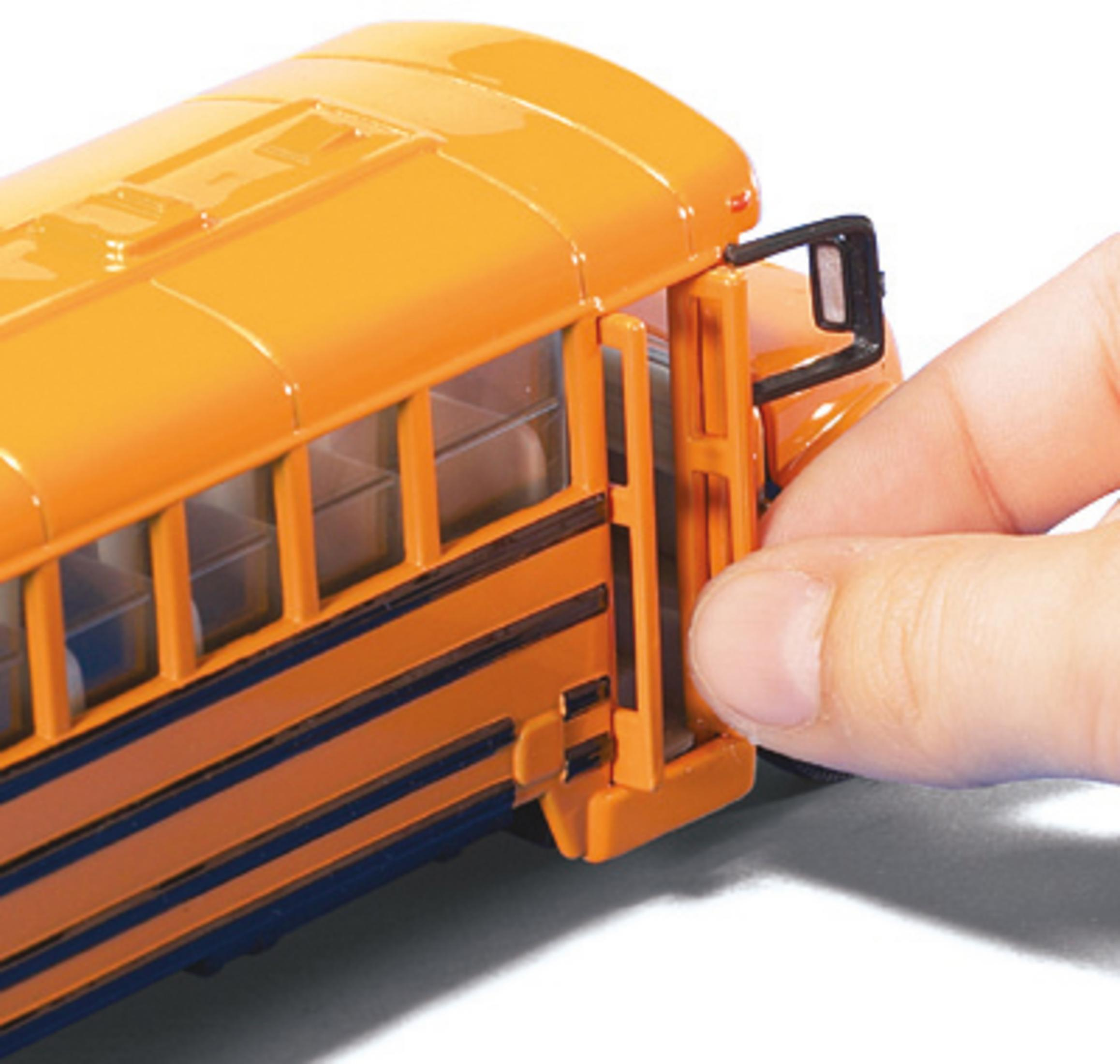 Hand öffnet eine Schulbustür, orangefarbener Bus mit schwarzen Streifen.