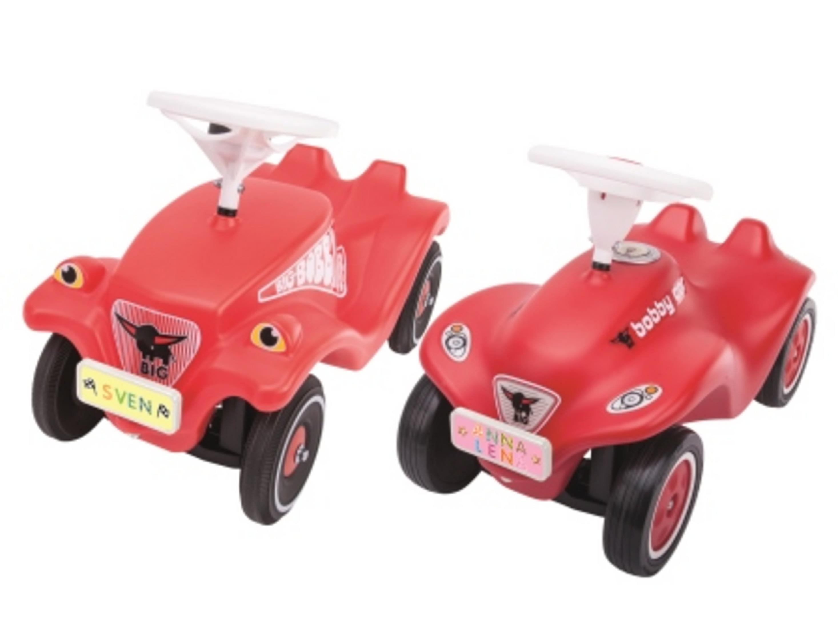 Dwa czerwone autka z białymi kierownicami, z imionami 'SVENA' i 'FINA LENA'.