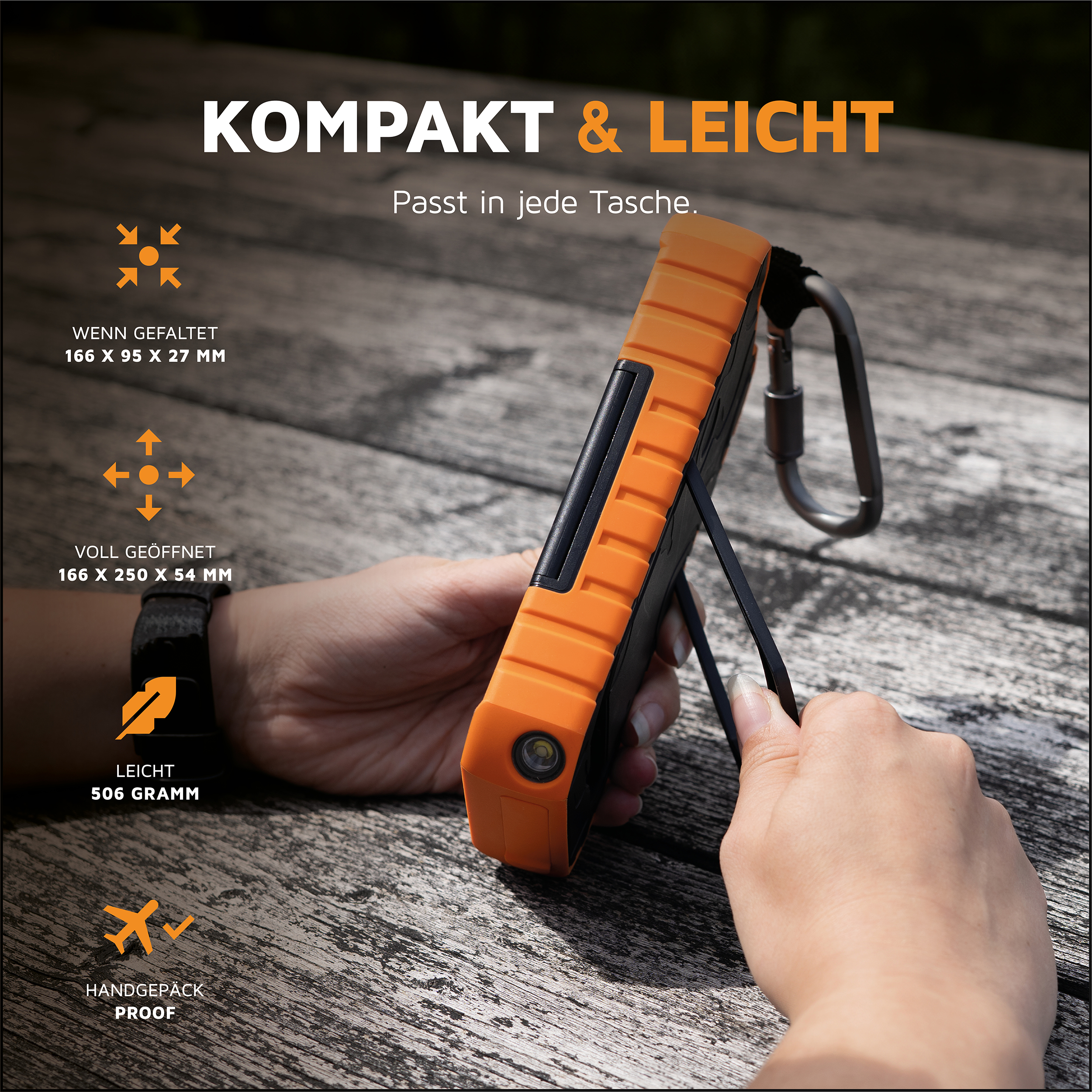 Orange-schwarzes Gerät in Händen auf Holztisch. Text: Kompakt & Leicht. Abmessungen.