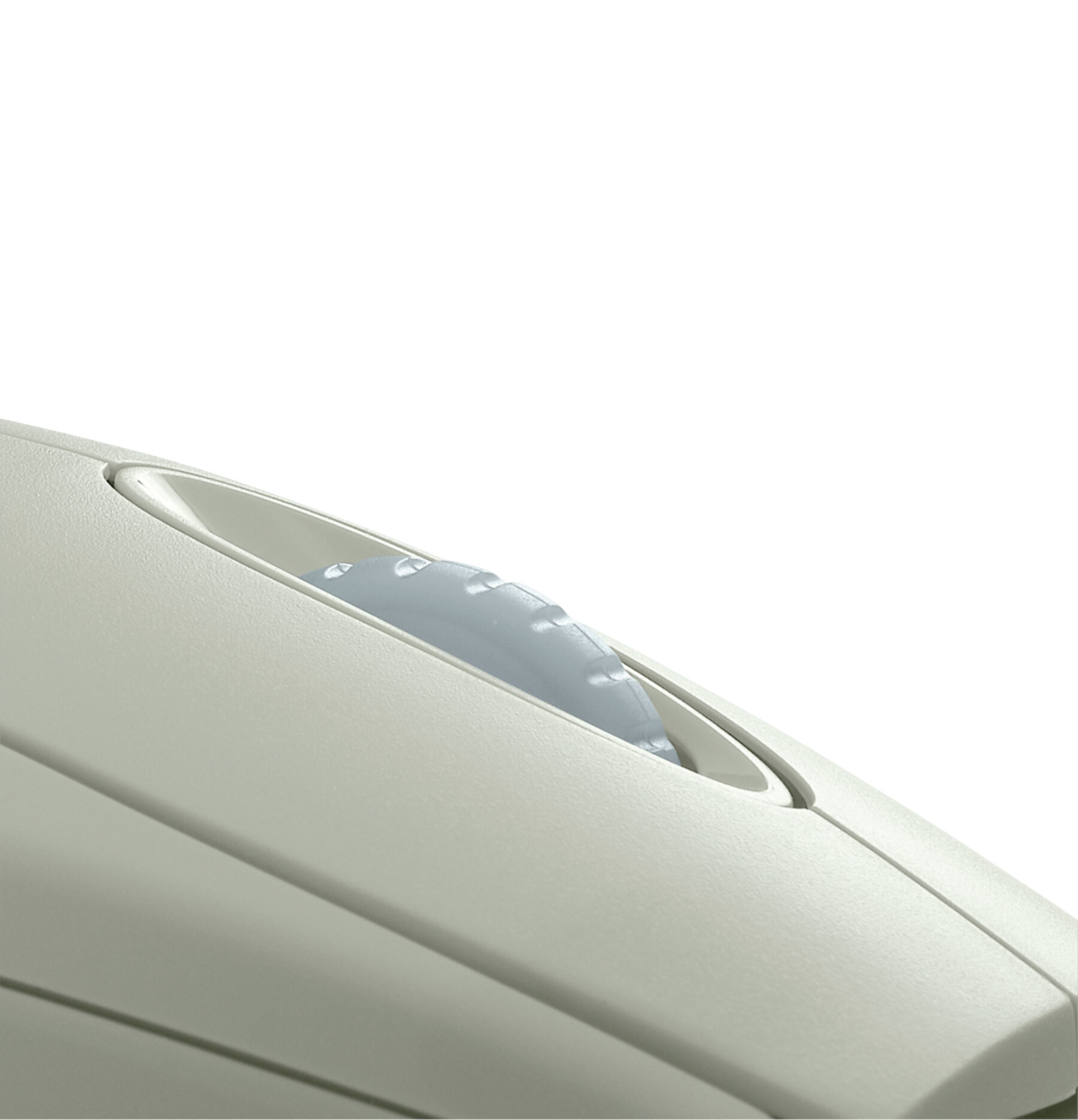 Close up of a light grey plastic button on a light grey surface.