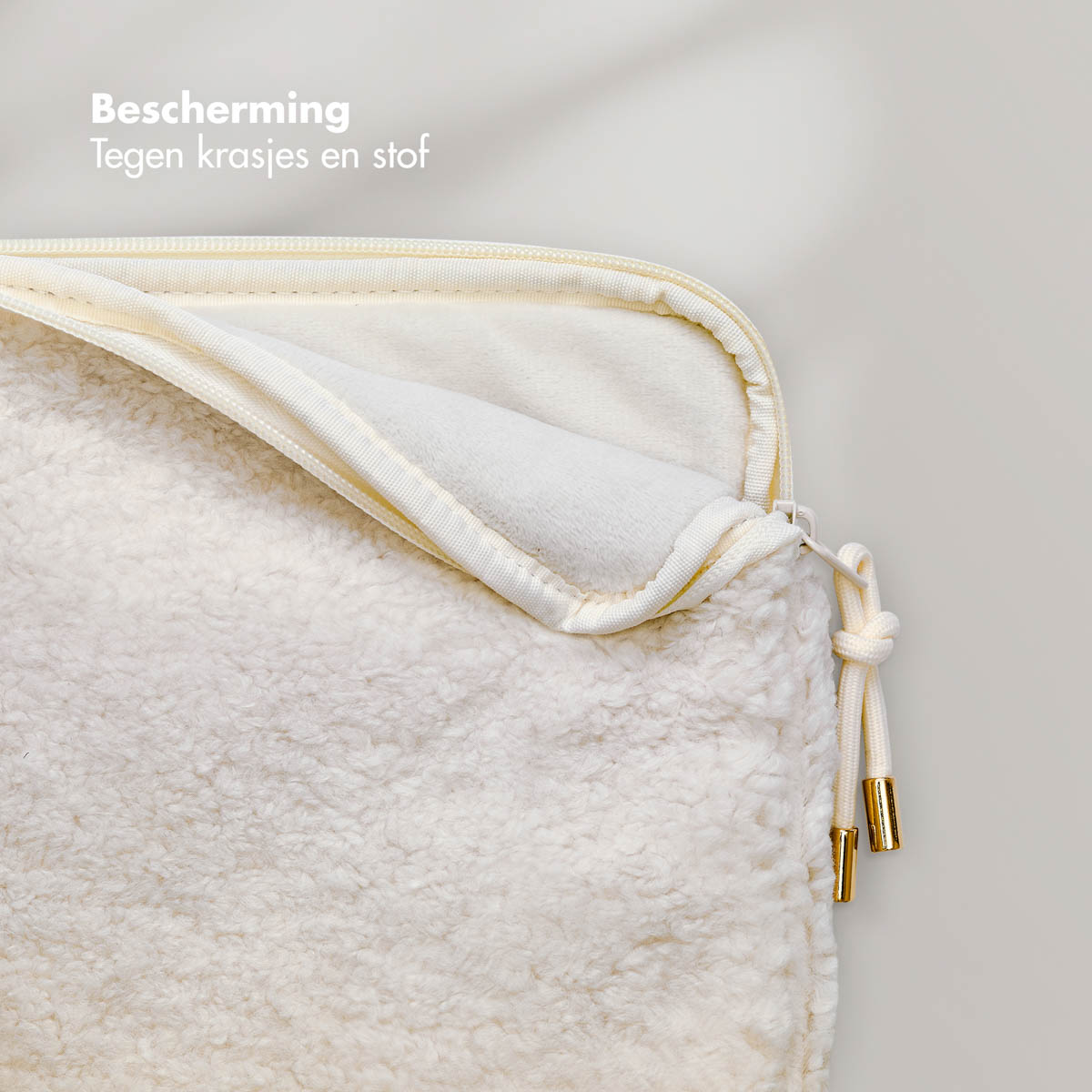 A cream-colored laptop sleeve with a zipper and a drawstring. Text says 'protection'.