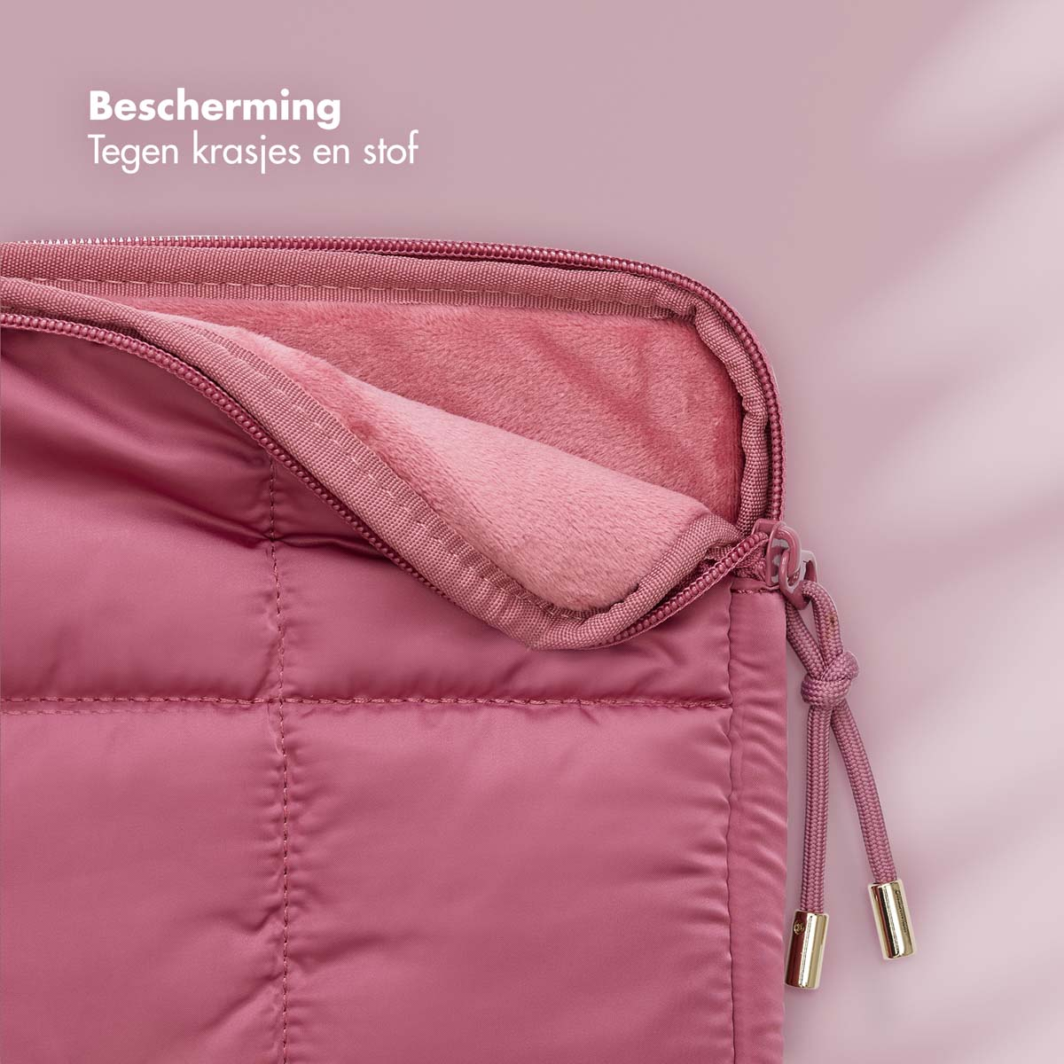 Pink laptop sleeve with zipper. Inside is a soft, light pink lining.  The background is a similar pink.