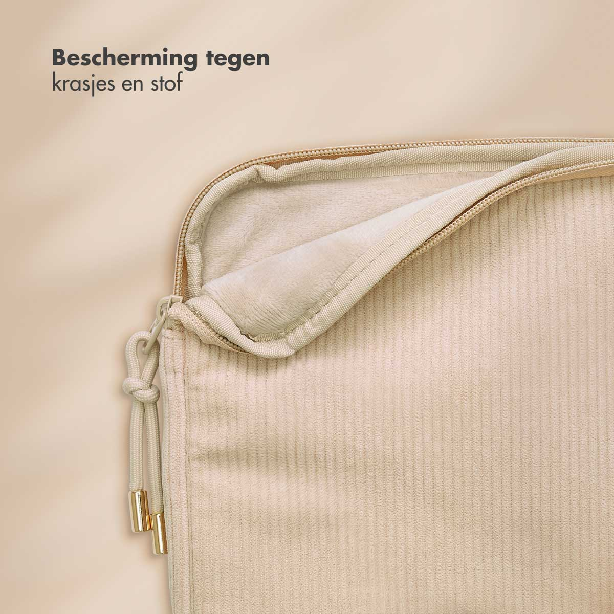 Close-up of a beige corduroy laptop sleeve with a zipper and gold details.