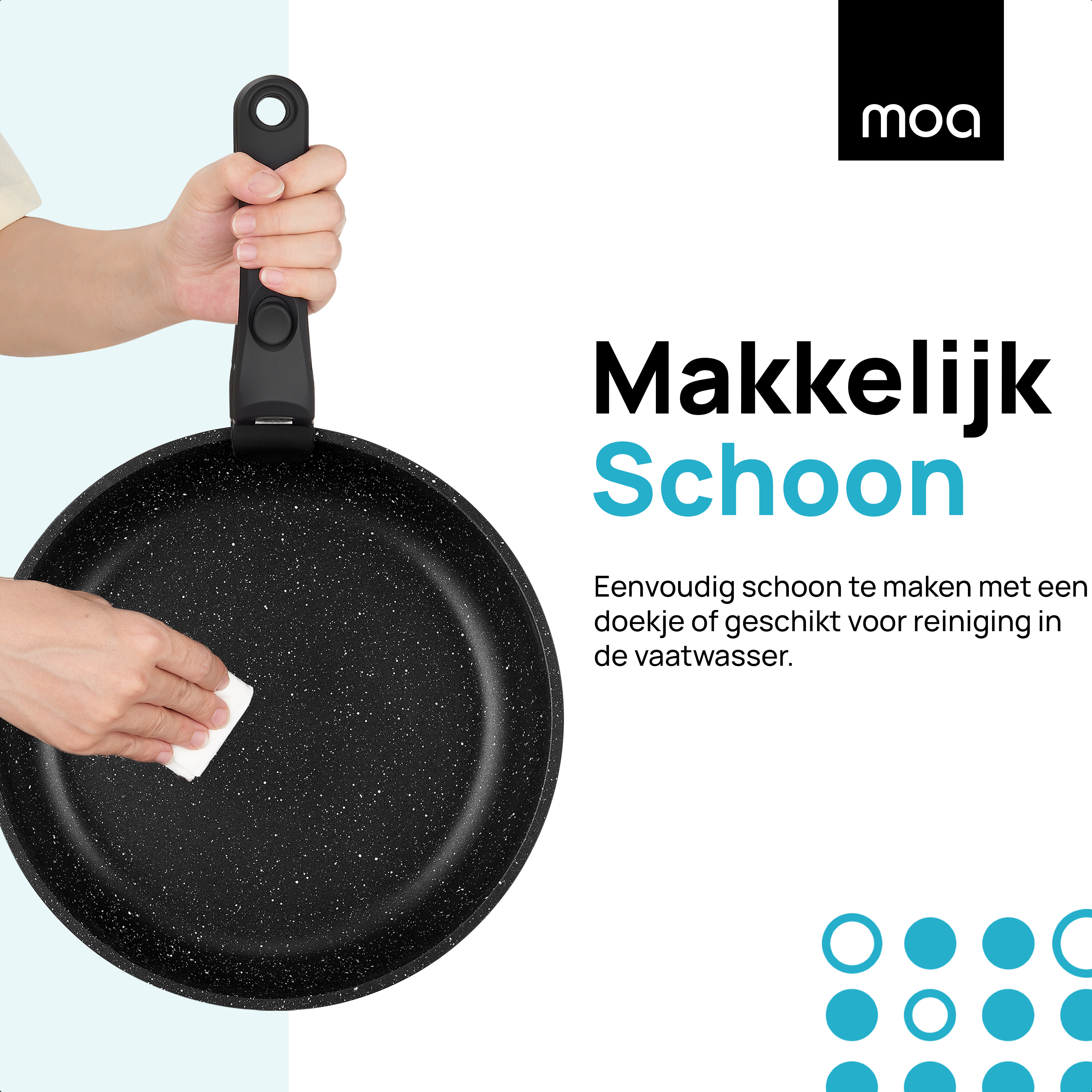 A black frying pan with a hand holding the handle and a white cloth wiping it.