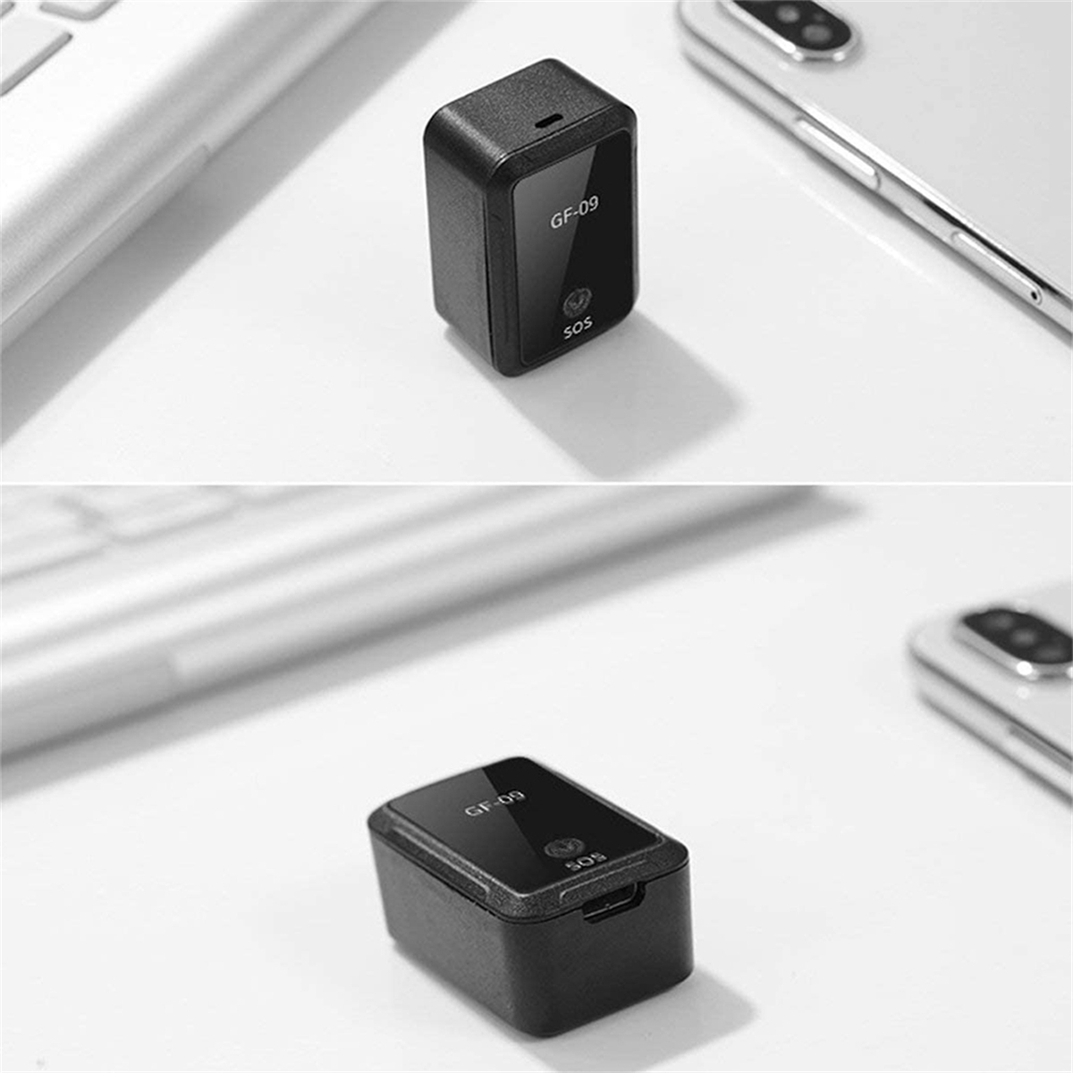 Zwei schwarze GPS-Tracker auf weißer Oberfläche. Ein Laptop und ein Telefon im Hintergrund.