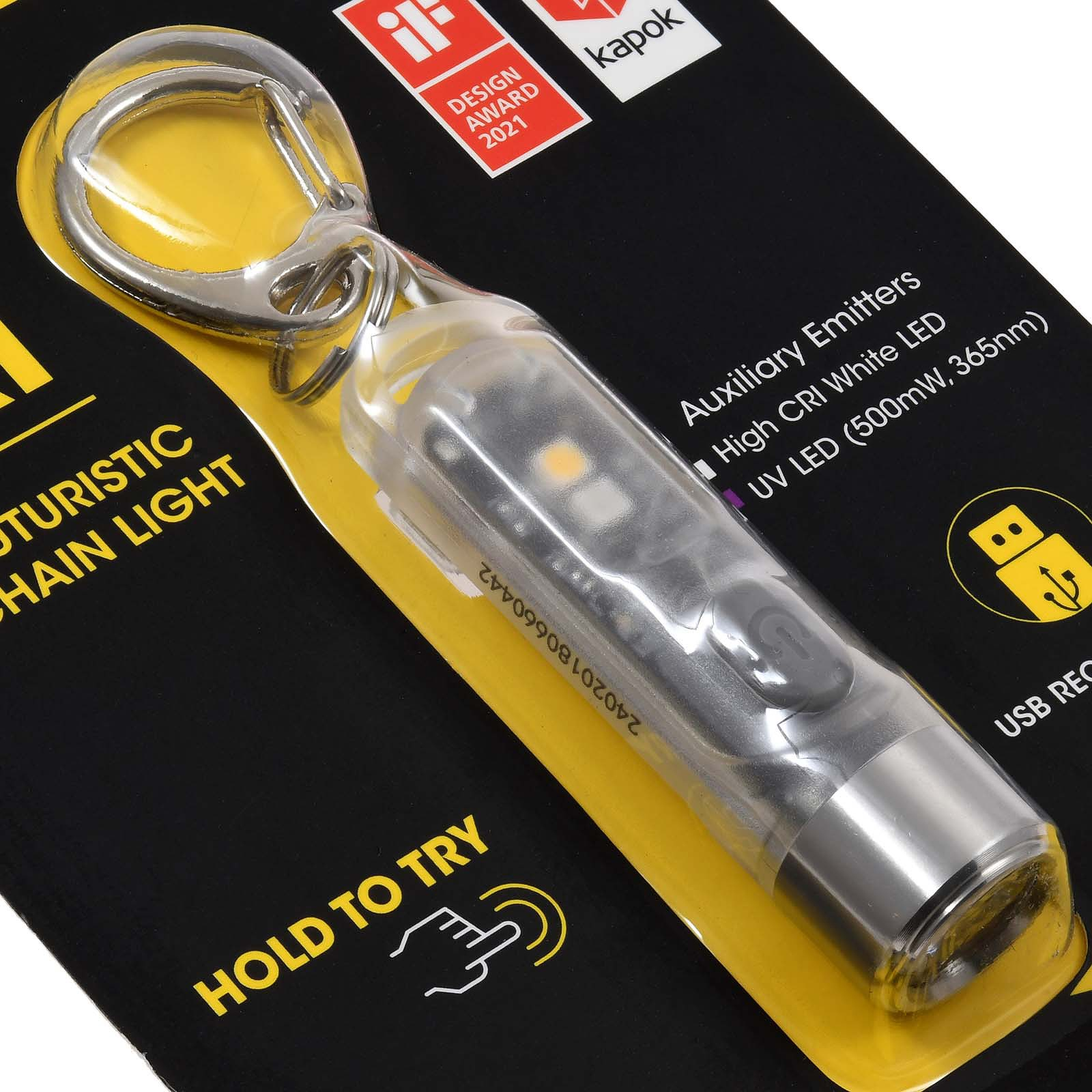 Eine Taschenlampe mit Schlüsselringbefestigung. Die Verpackung enthält Text, der auf zusätzliche Strahler und einen USB-Anschluss hinweist.