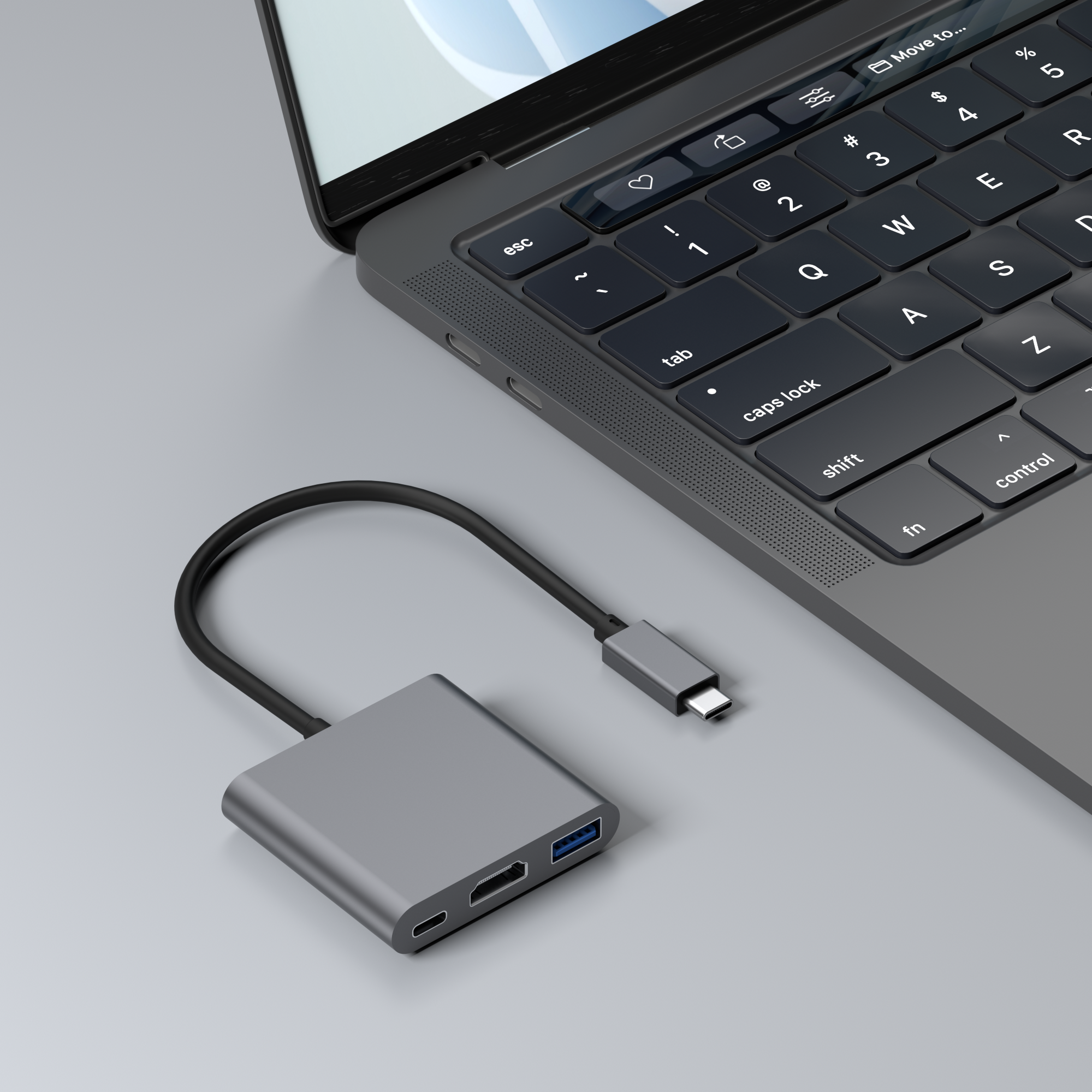 Hub USB-C gris connecté à un ordinateur portable. Hub a ports HDMI et USB. Clavier visible.
