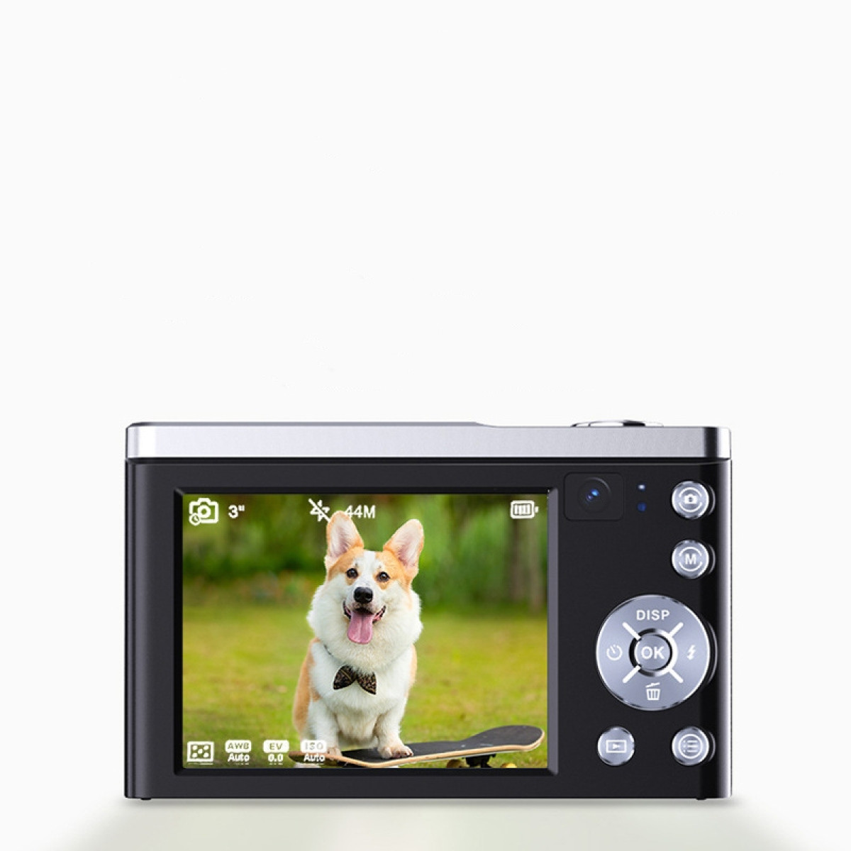 Czarny aparat wyświetla corgi w muszce na deskorolce. Widoczne elementy sterowania aparatu.