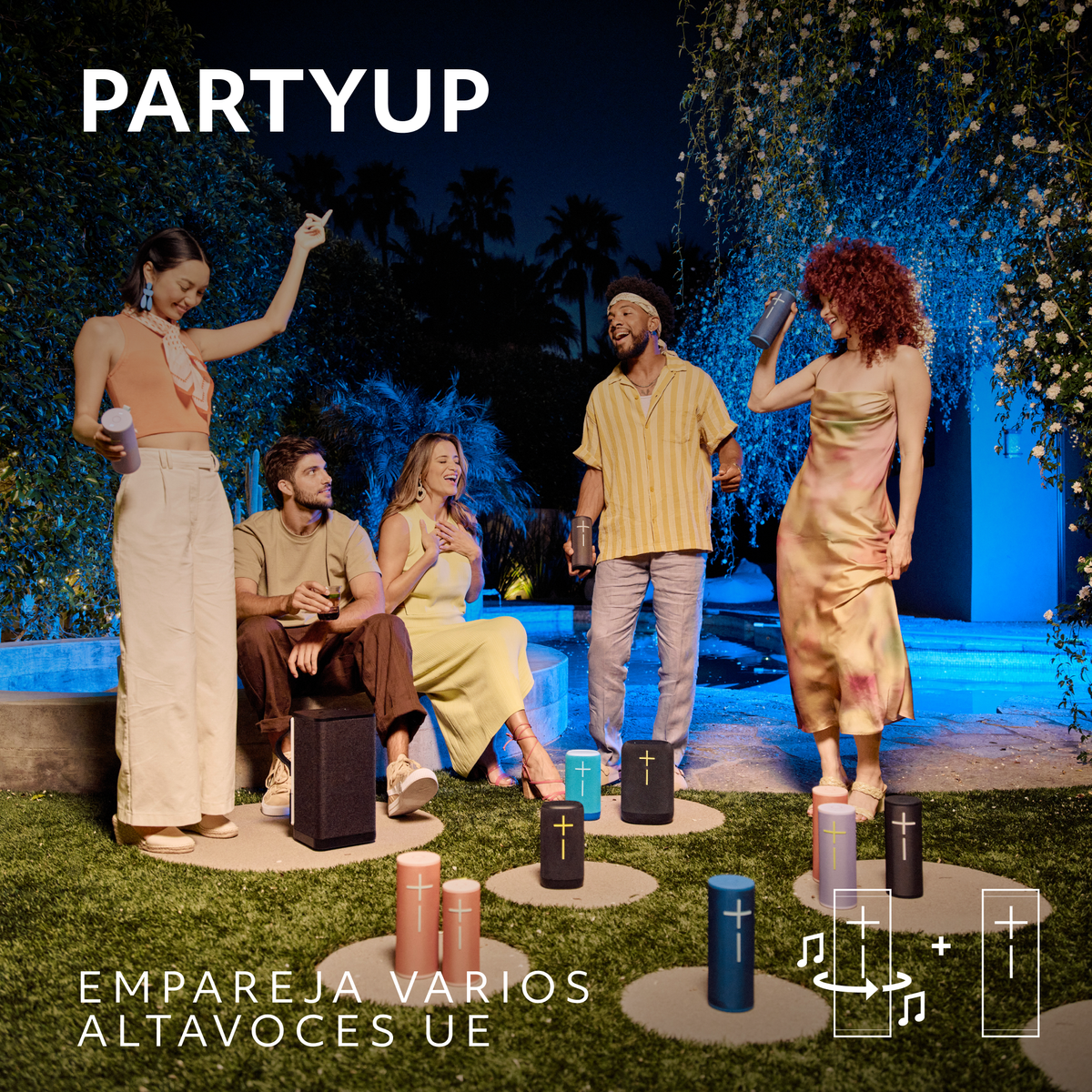 Grupa osób na imprezie z głośnikami. Niektórzy tańczą i trzymają drinki.