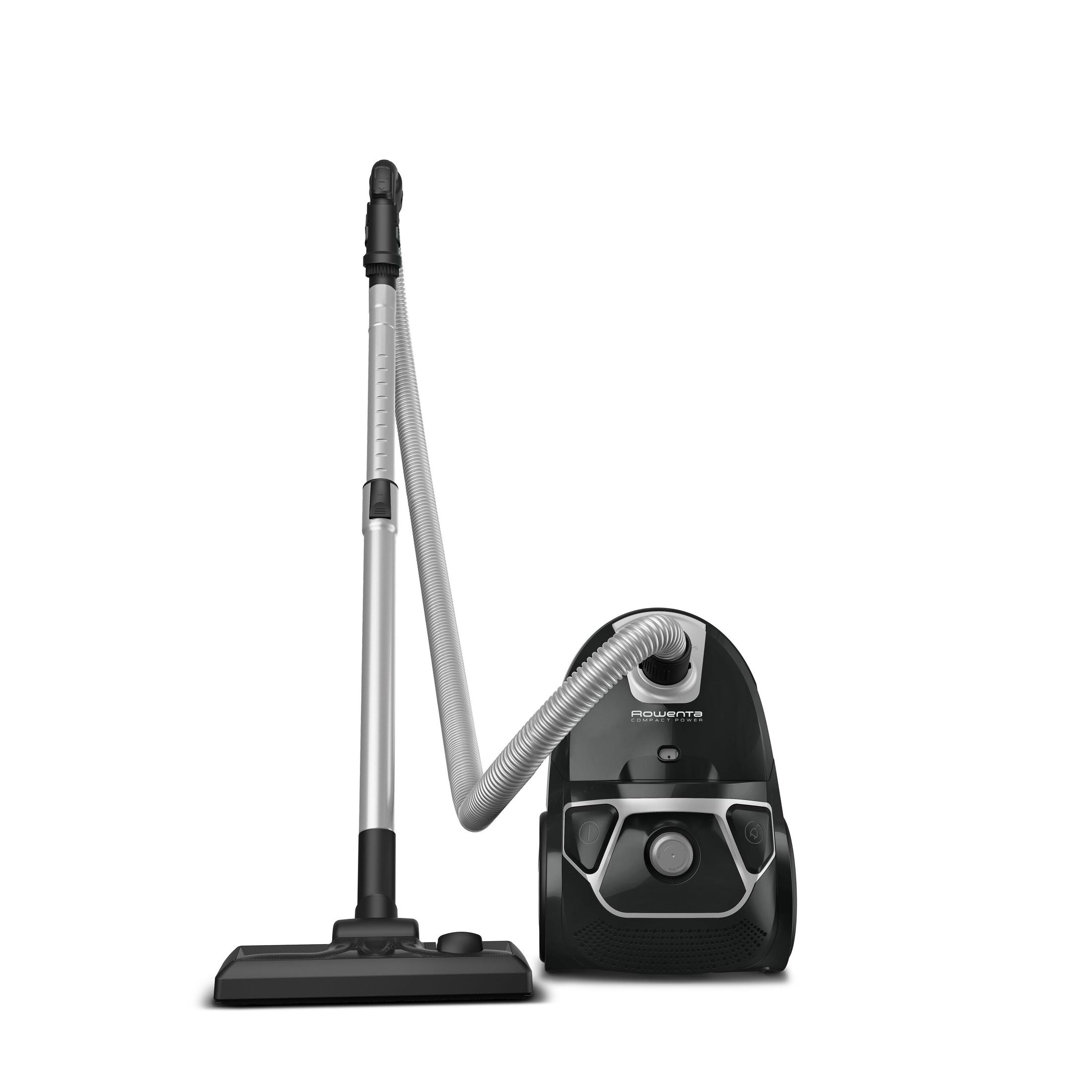 Un aspirateur noir. Il a un tuyau, une canne et une tête de nettoyage.