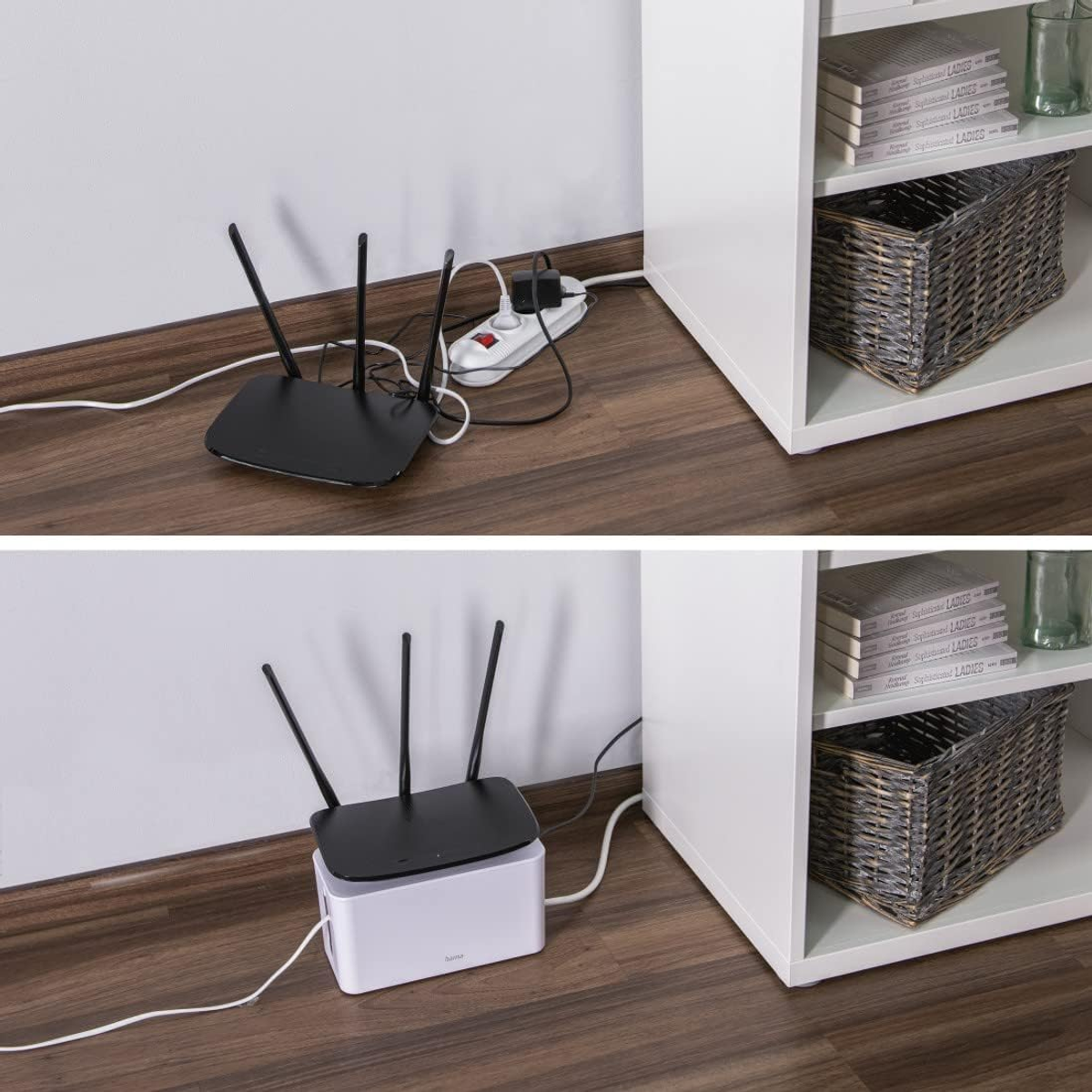 Ein Router mit Antennen steht auf dem Boden und ist an eine Steckdosenleiste angeschlossen.