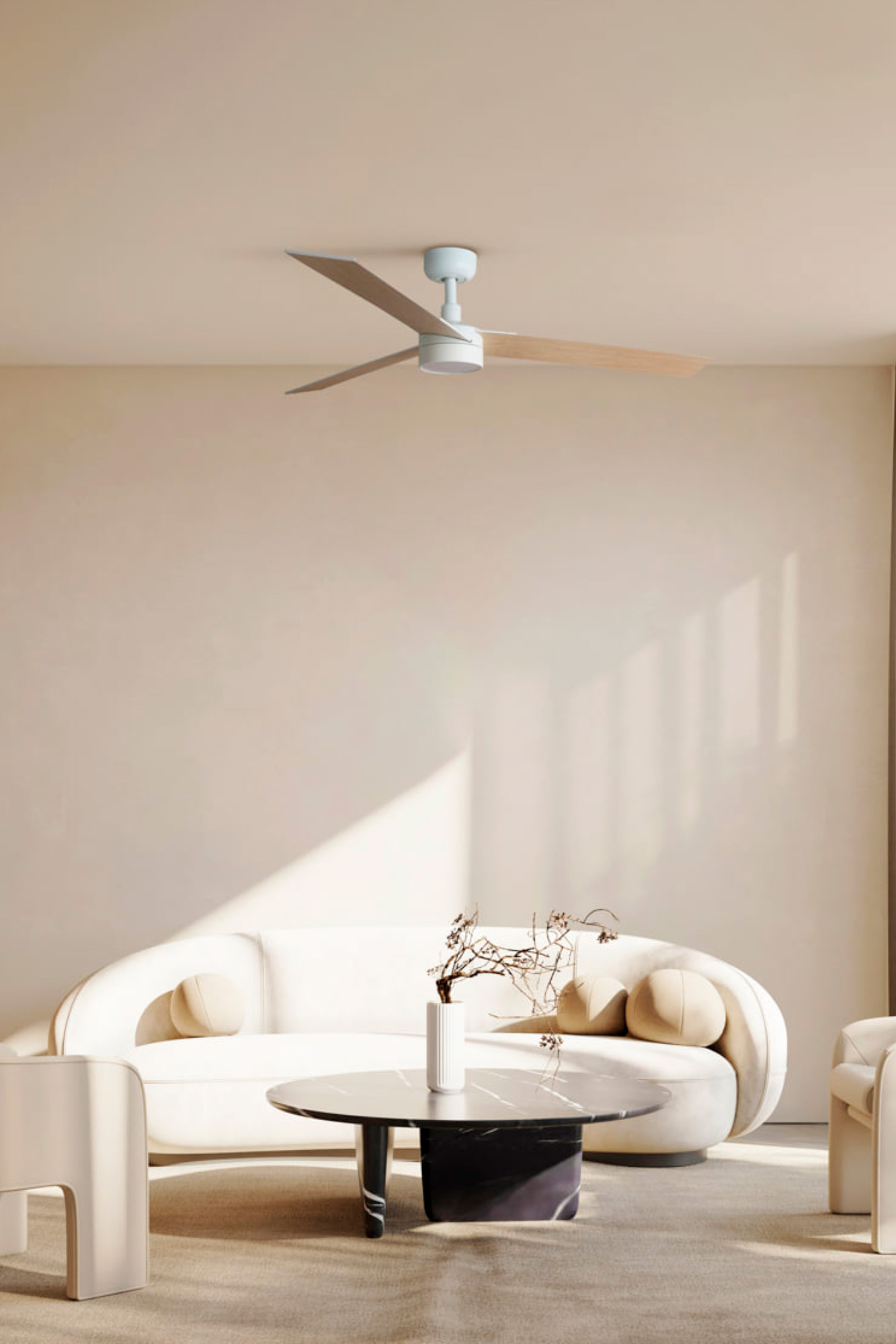 Ein Wohnzimmer mit weißem Sofa, rundem Tisch und Deckenventilator.