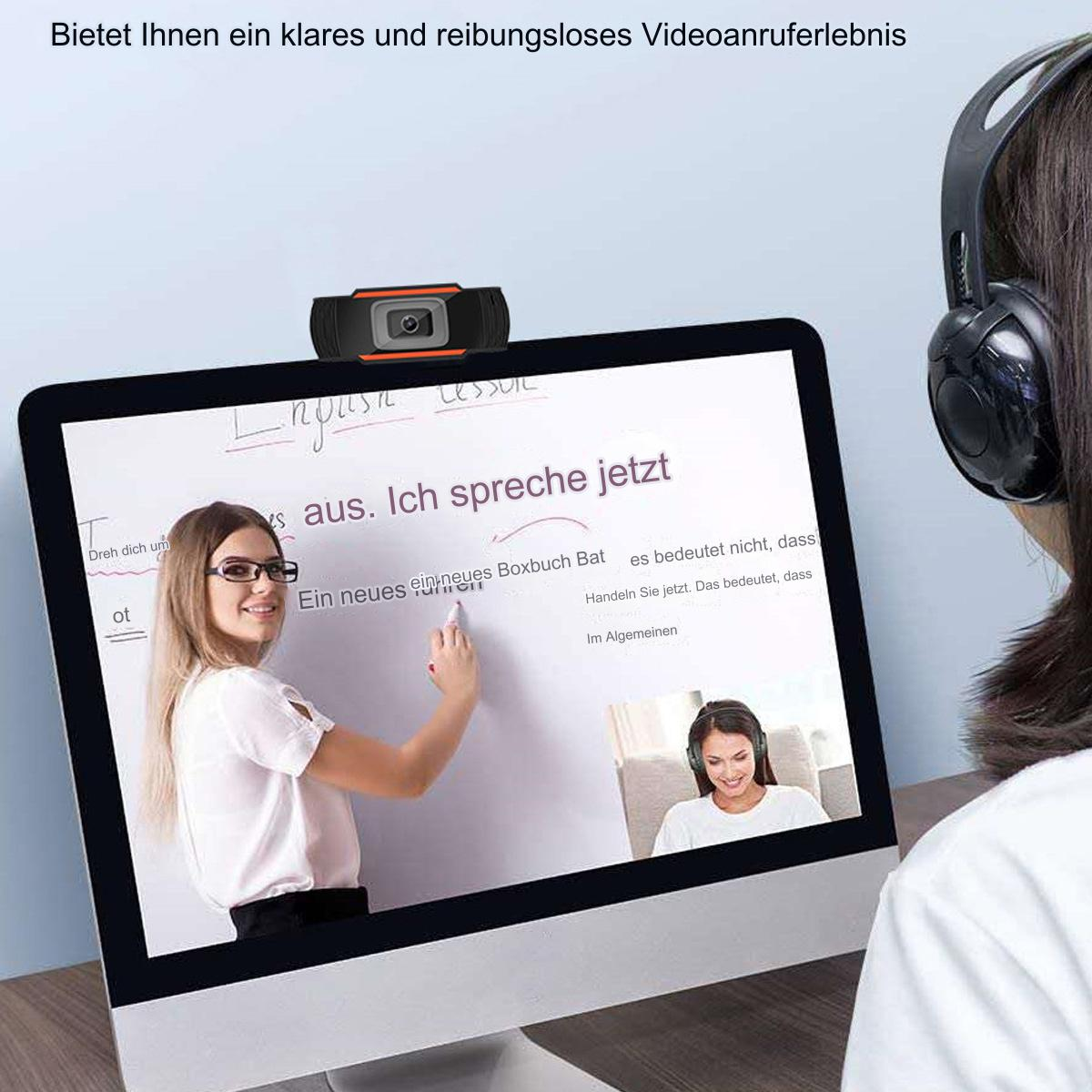 Eine Frau unterrichtet online Englisch, mit einem Monitor und einer Webcam.