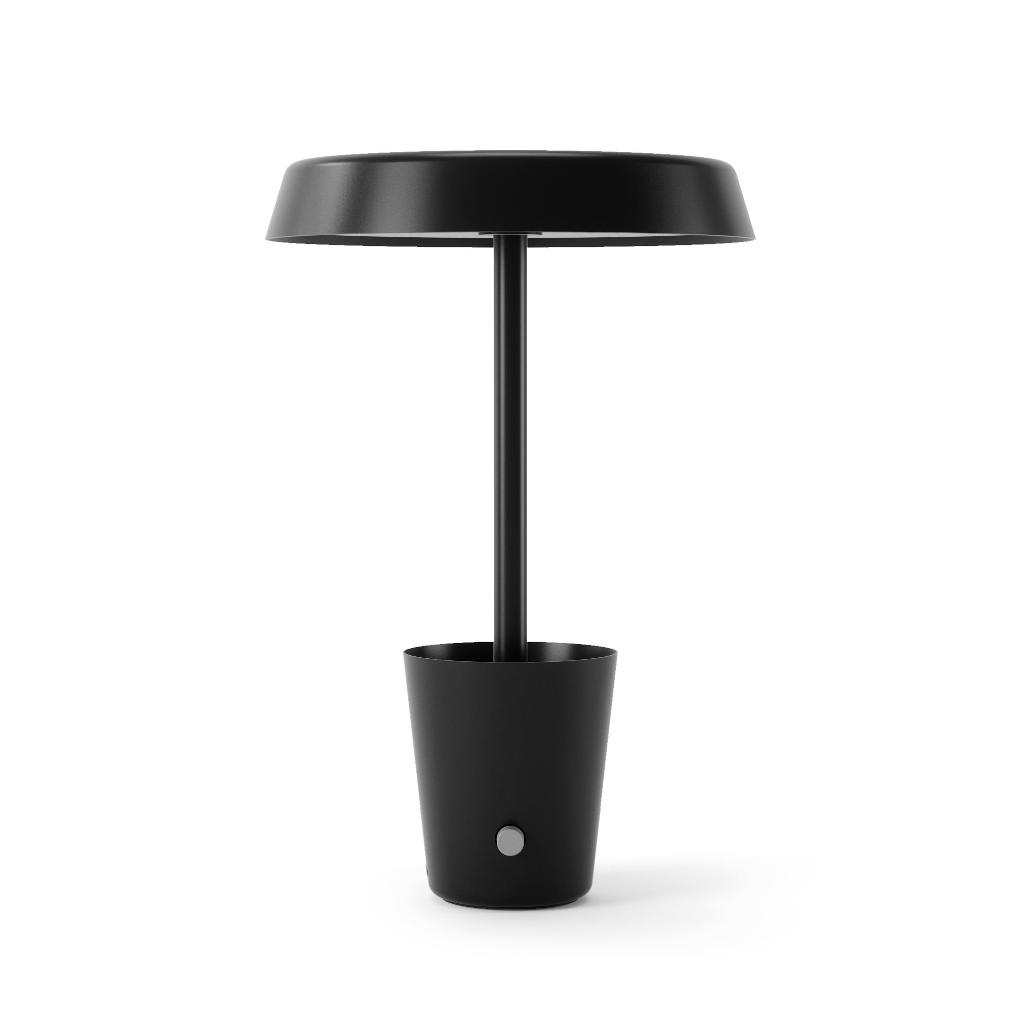Una lampada da tavolo nera con parte superiore rotonda e base cilindrica. È su una superficie bianca.