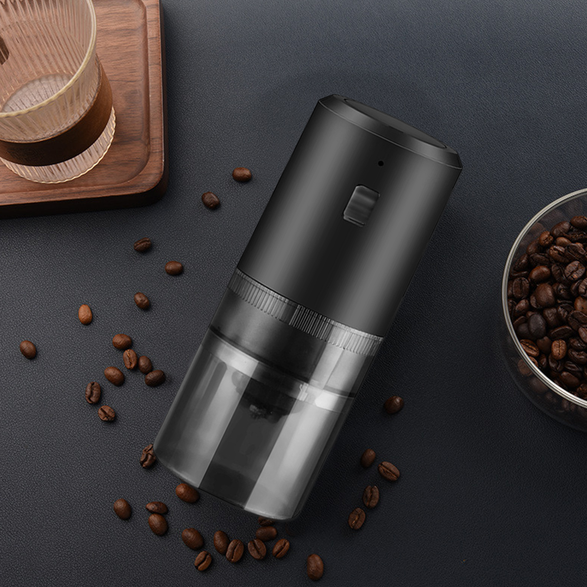 Schwarze Kaffeemühle mit transparentem Boden. Kaffeebohnen sind drum herum.