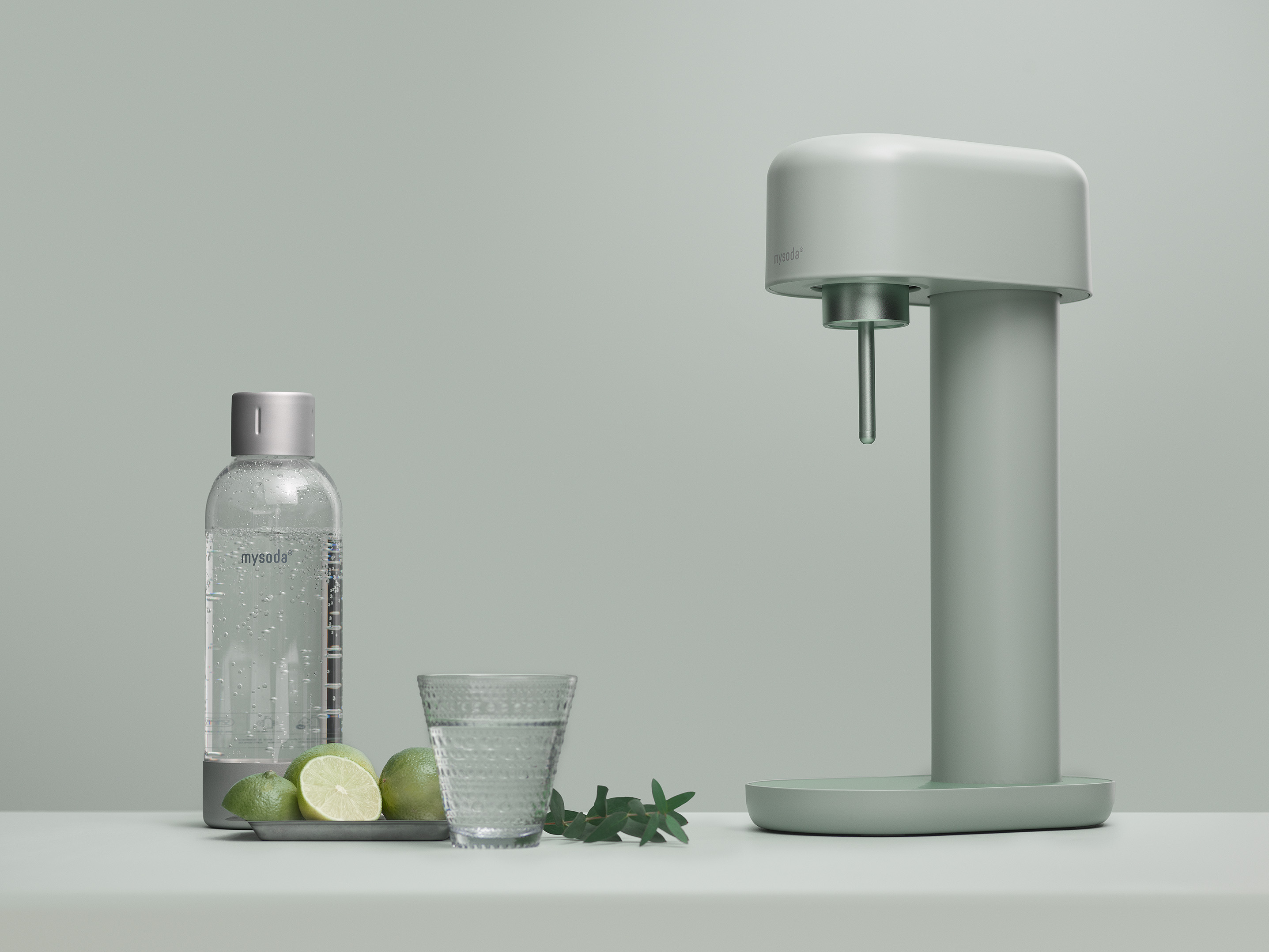 Soda maker, glass of water, and a bottle. Limes on a plate.