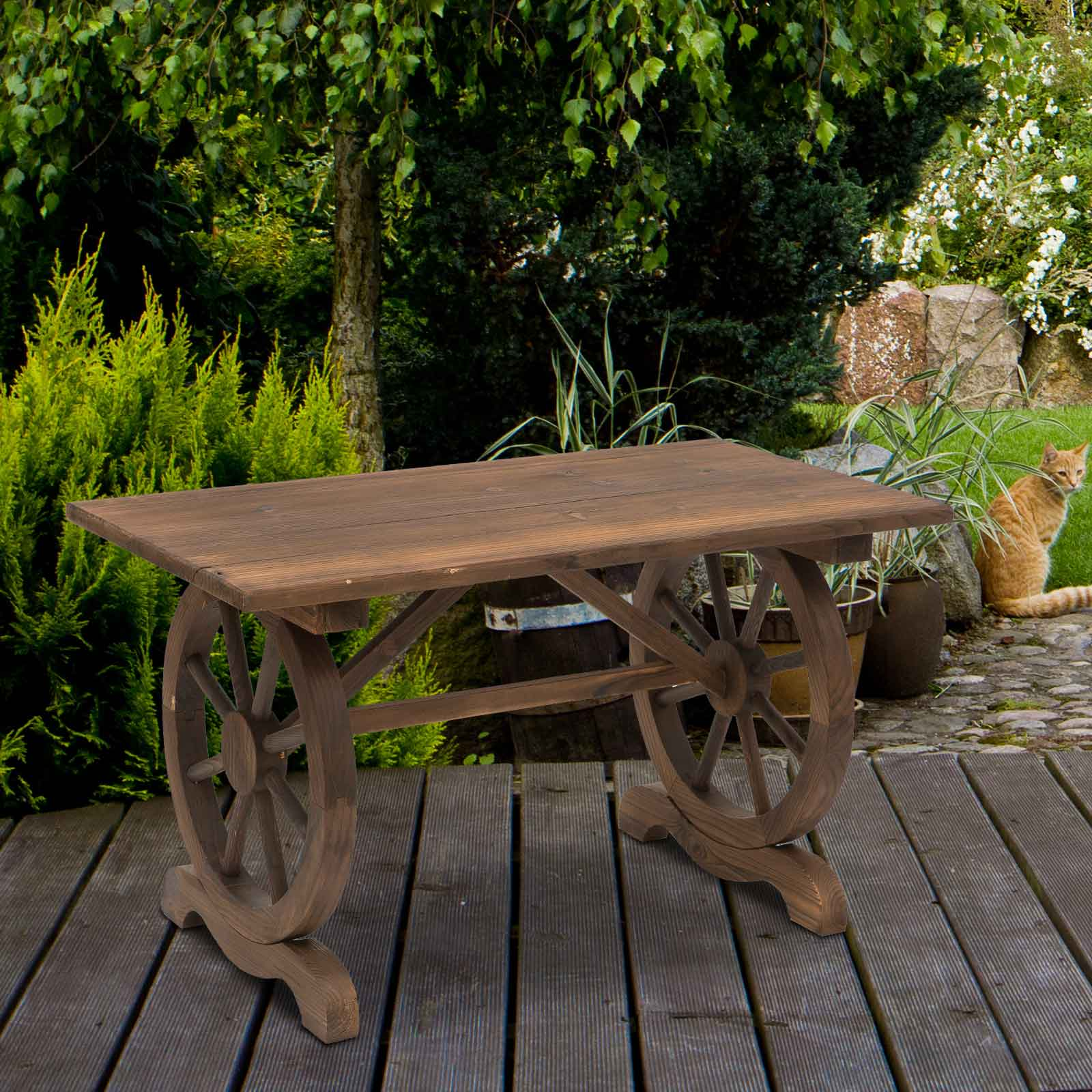 Tavolo in legno con gambe a ruota di carro su una terrazza in legno, gatto sullo sfondo.