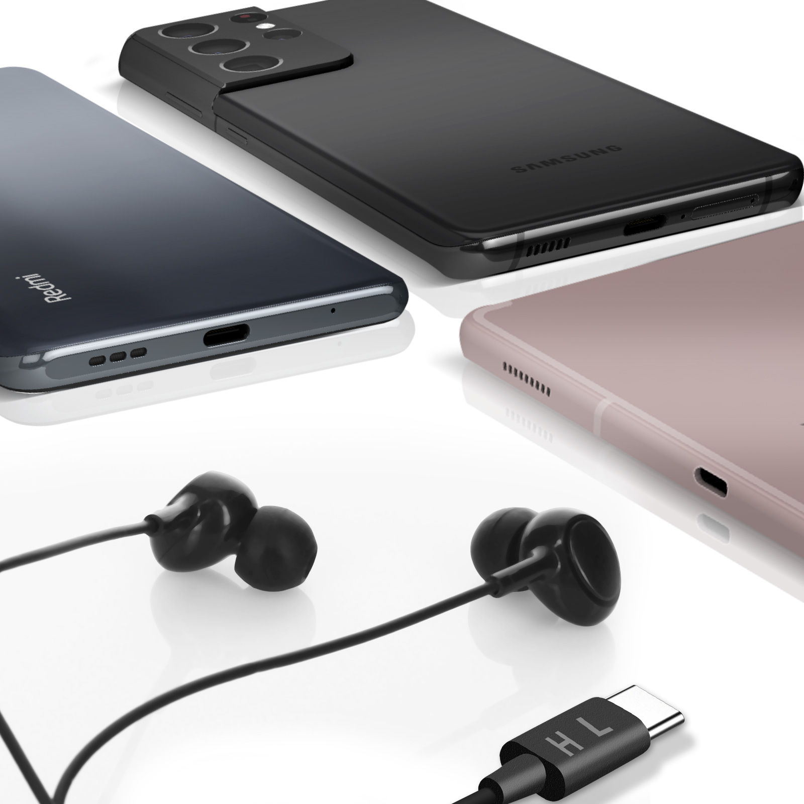 Tres teléfonos y auriculares sobre una superficie blanca. Los teléfonos son negro, rosa y degradado.