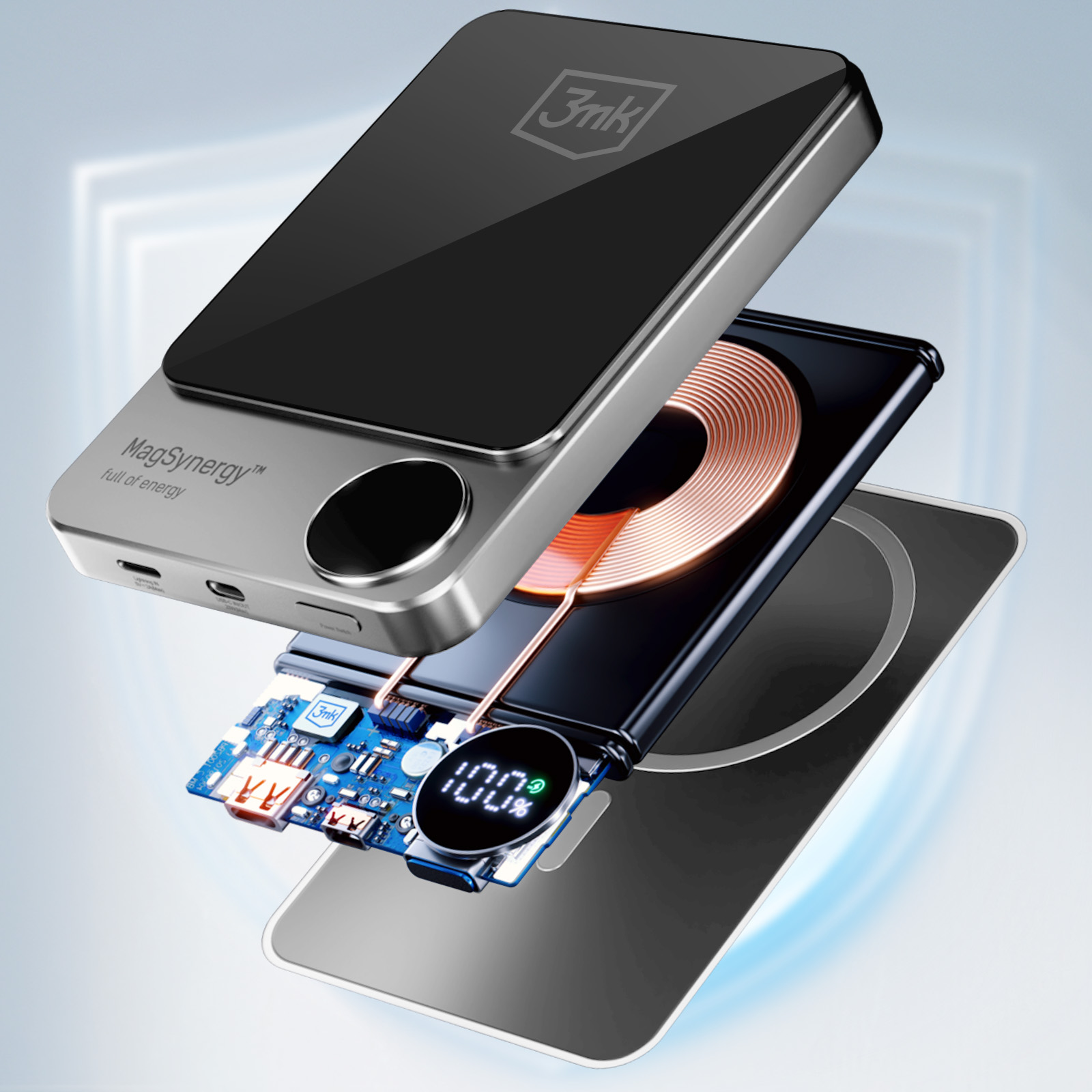 Srebrna i czarna ładowarka bezprzewodowa z logo MagSynergy, telefonem, płytką drukowaną, wskaźnikiem 100% i cewką ładującą.