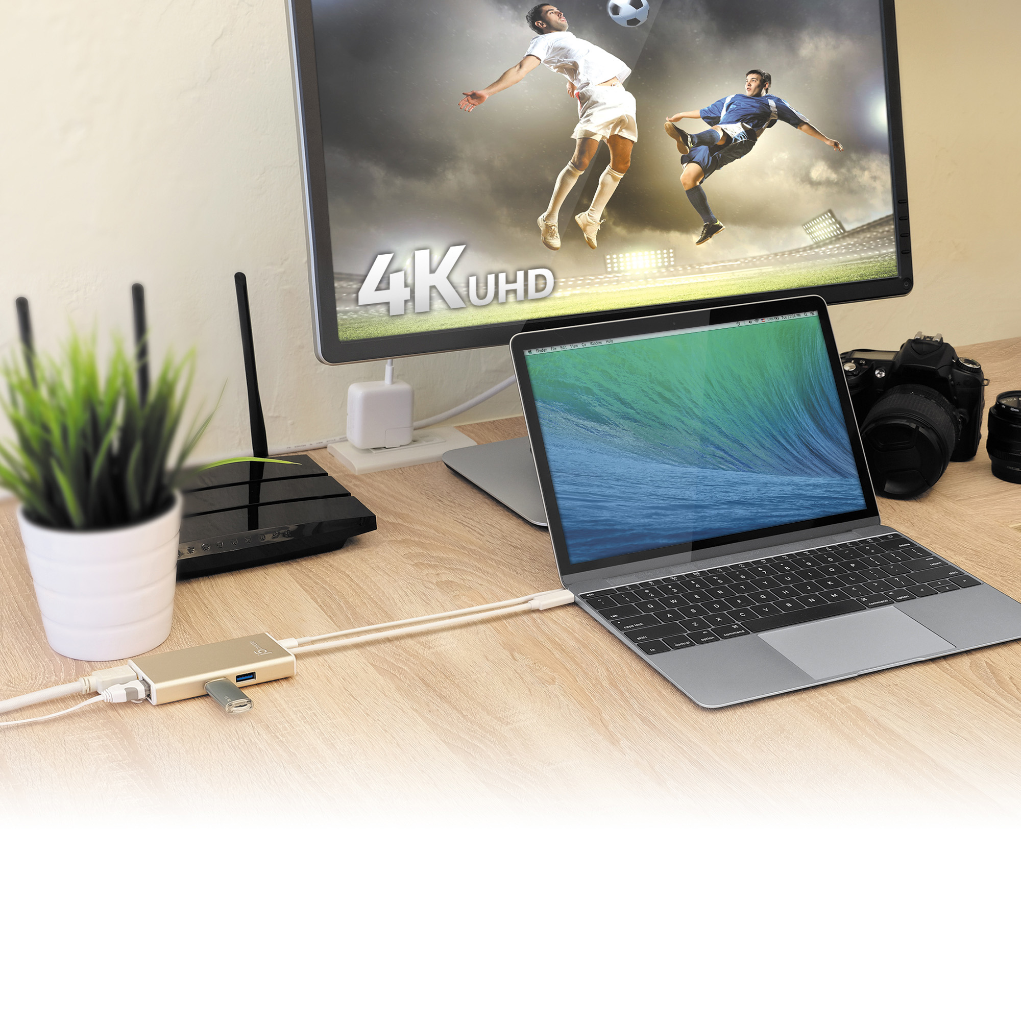 Ein Schreibtisch mit Laptop, Monitor und anderen Geräten.