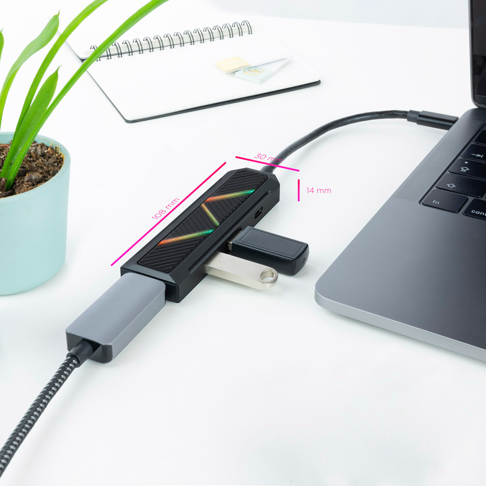 Concentrador USB conectado a una laptop. Una memoria flash está insertada. Las dimensiones están etiquetadas.