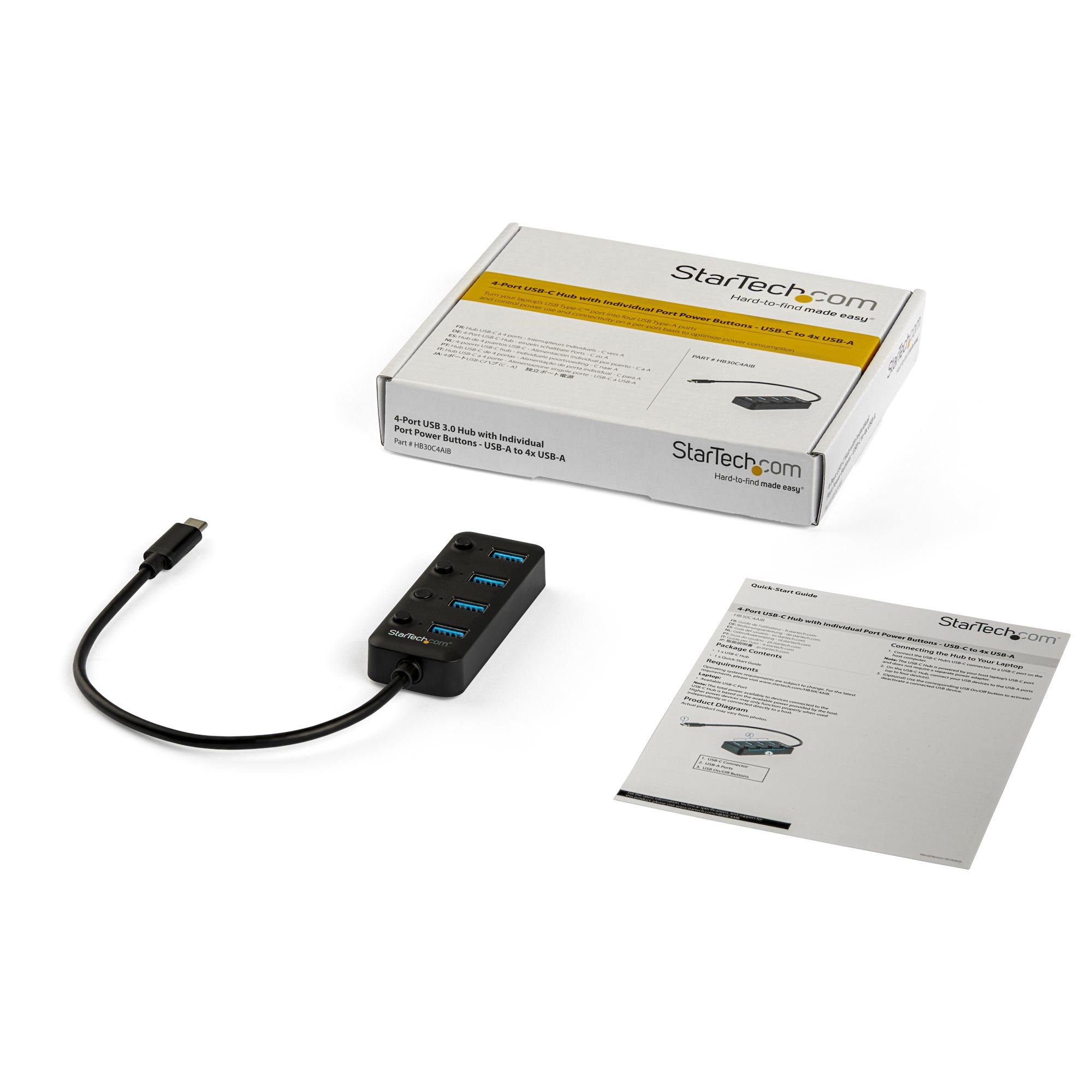 Ein USB-Hub mit Box und Handbuch auf weißem Hintergrund. Schwarzer Hub mit USB-Anschlüssen.
