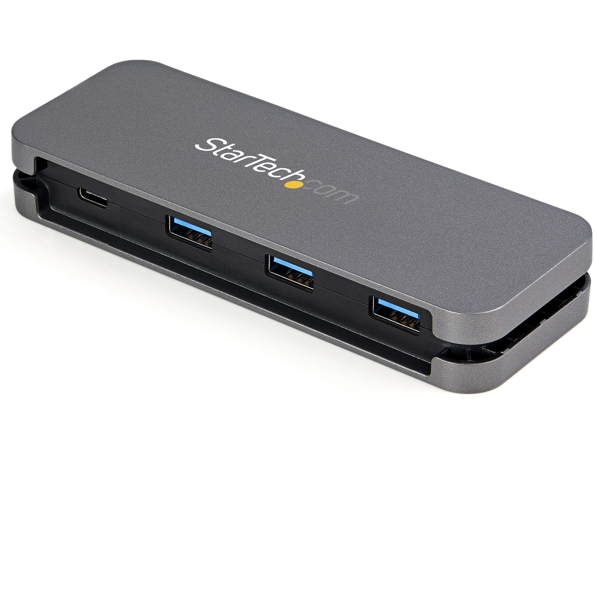 Un concentrador USB gris con cuatro puertos. El concentrador está sobre una superficie blanca.