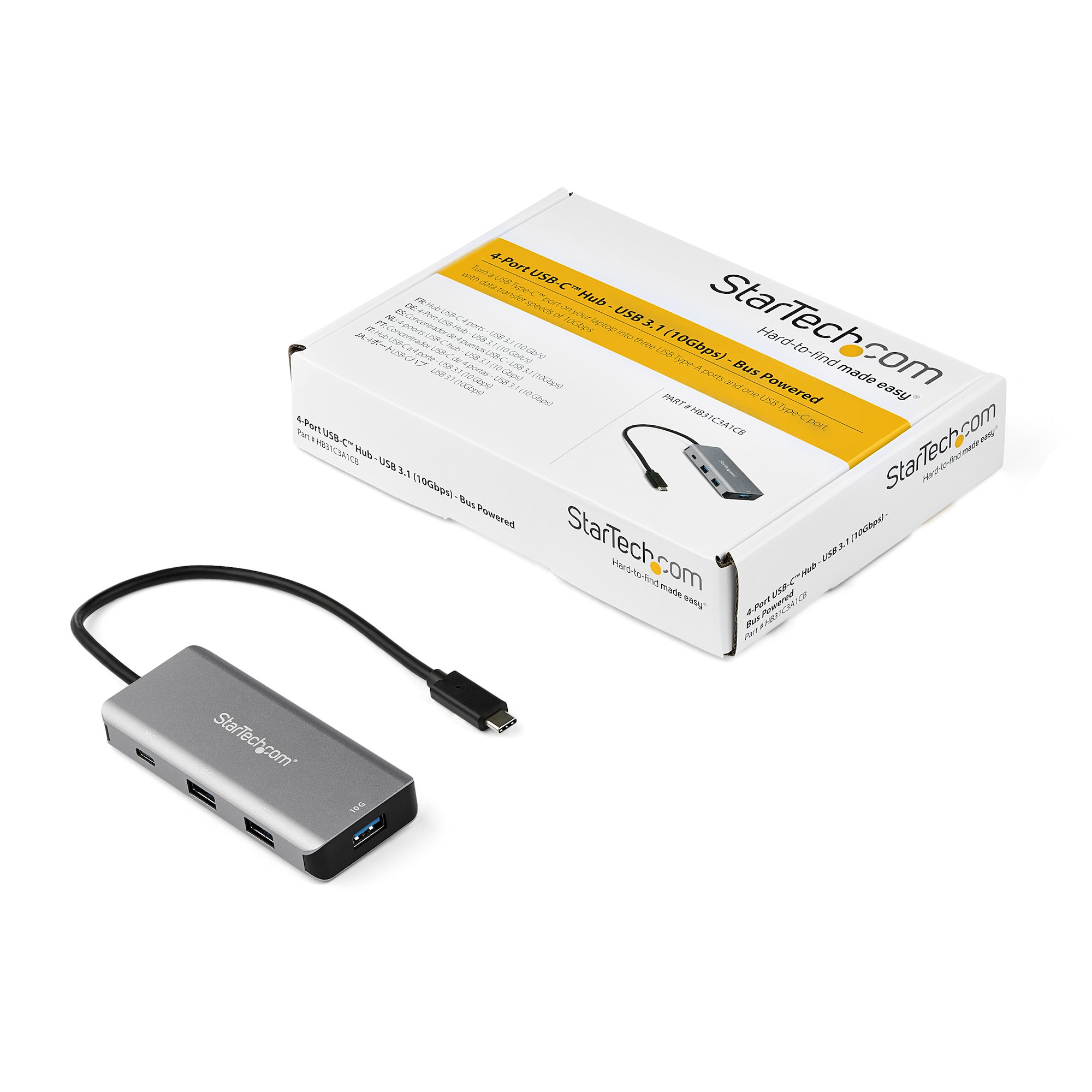 Concentrador USB-C plateado con cuatro puertos, caja y cable. La caja es blanca con texto.