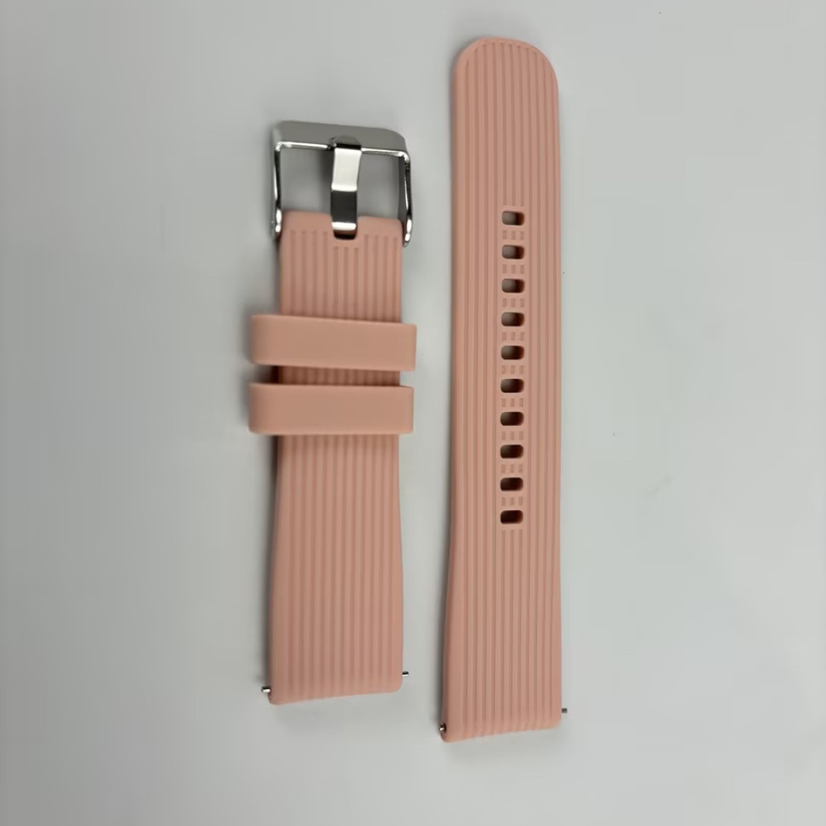 Rosa Uhrenarmbandteile, mit silberner Schnalle auf weißem Hintergrund.